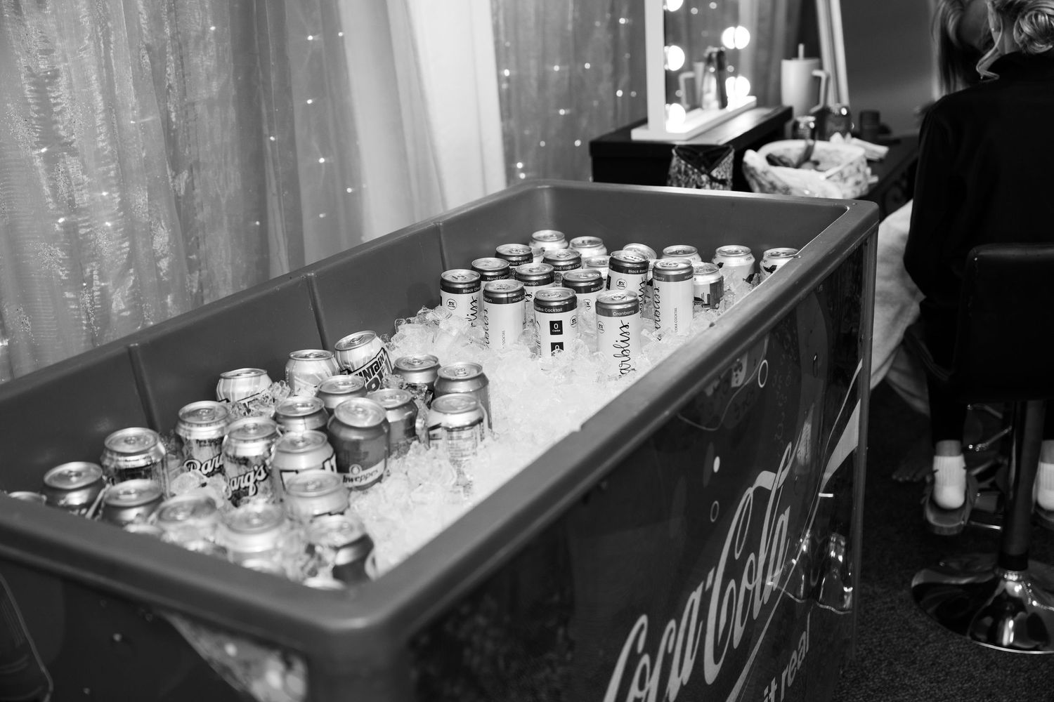 Glass jars with tea lights create a romantic ambiance along a decorative table setting at an evening event.