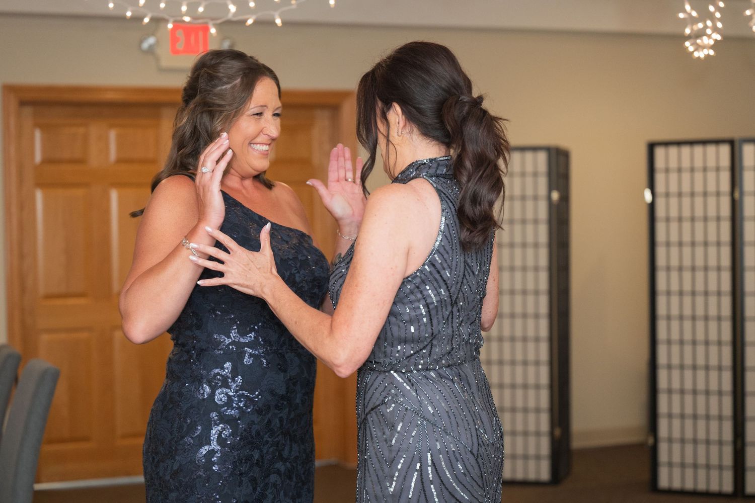 Two people in formal attire dance together under twinkling lights at an indoor venue. Pease Minnesota Wedding at Northern Lights Ballroom &