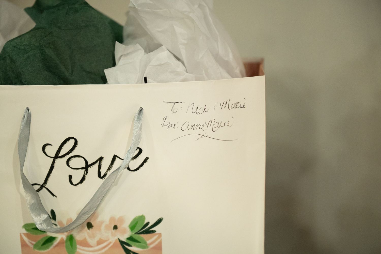 Wedding details including handwritten love notes and floral decorations in soft lighting.