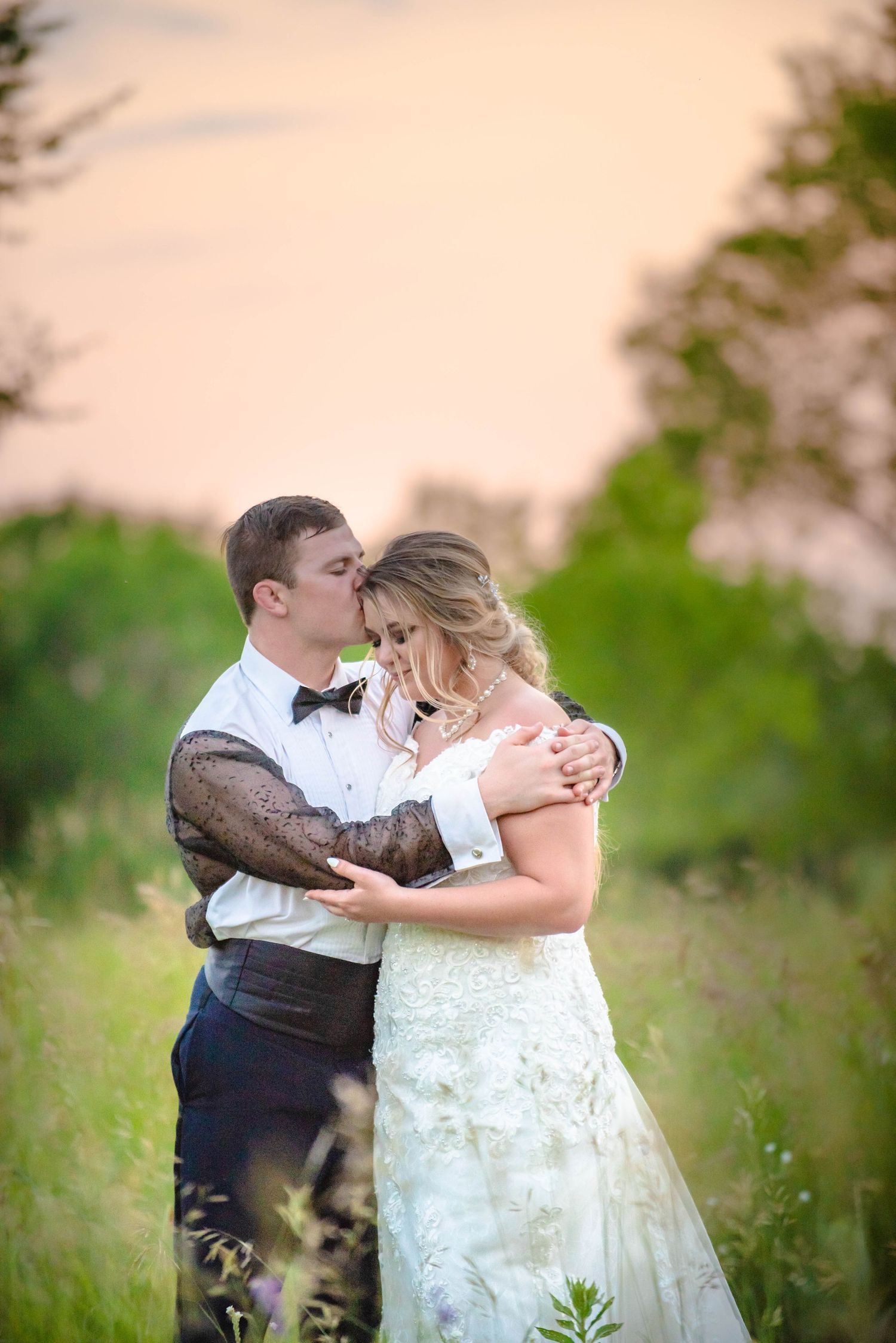 Romantic sunset wedding portraits in a meadow with soft natural lighting. Zimmerman MN Weddings