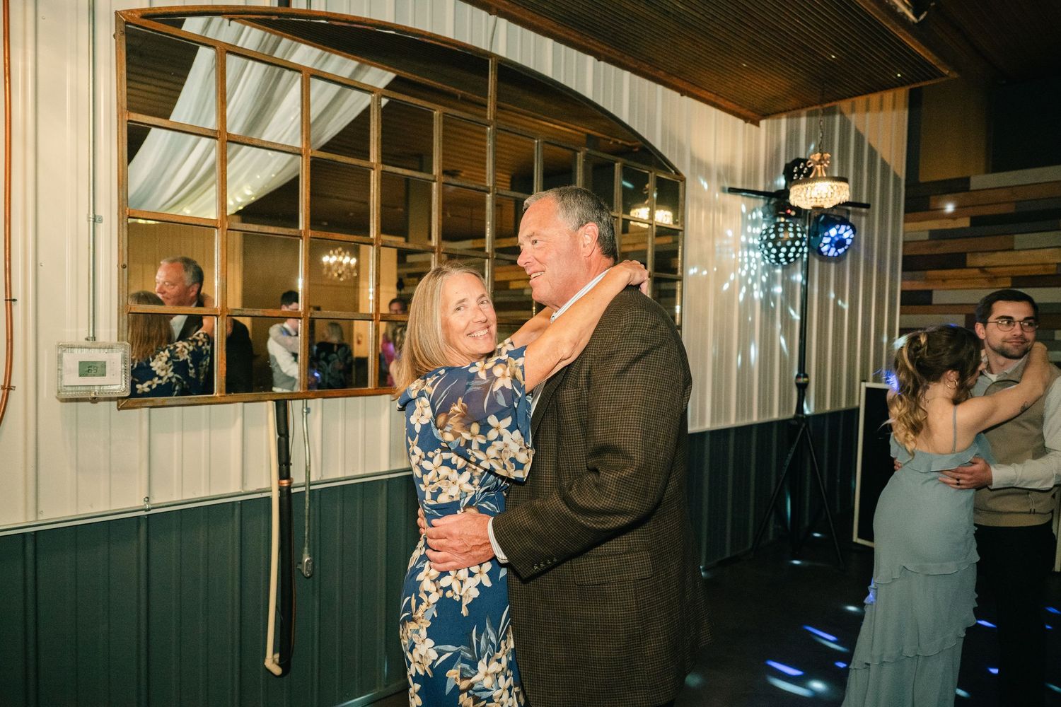 Couple sharing romantic dance at elegant wedding reception venue.