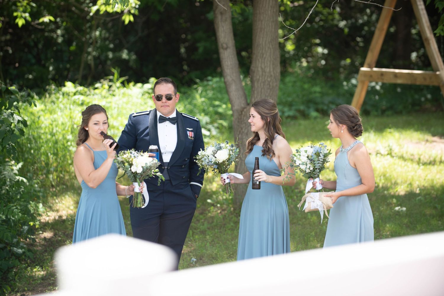 Wedding party in light blue dresses enjoying drinks outdoors. Zimmerman MN Weddings