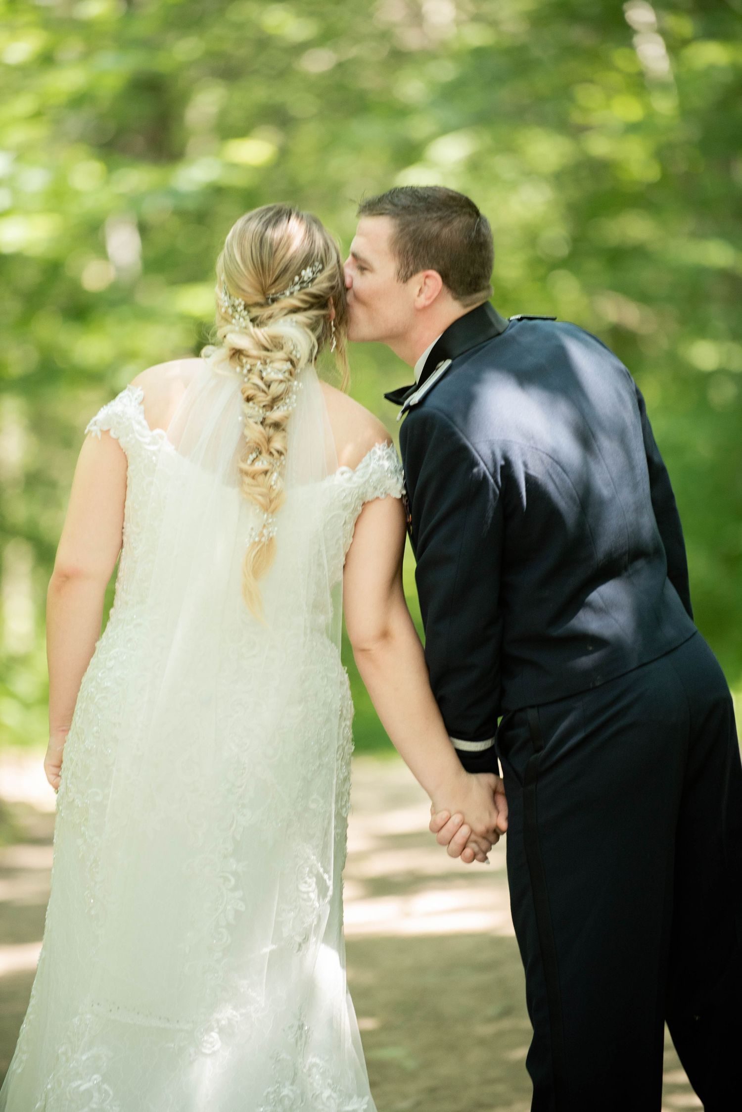A romantic wedding photo sequence showing a couple holding hands in a lush green outdoor setting. Zimmerman MN Weddings