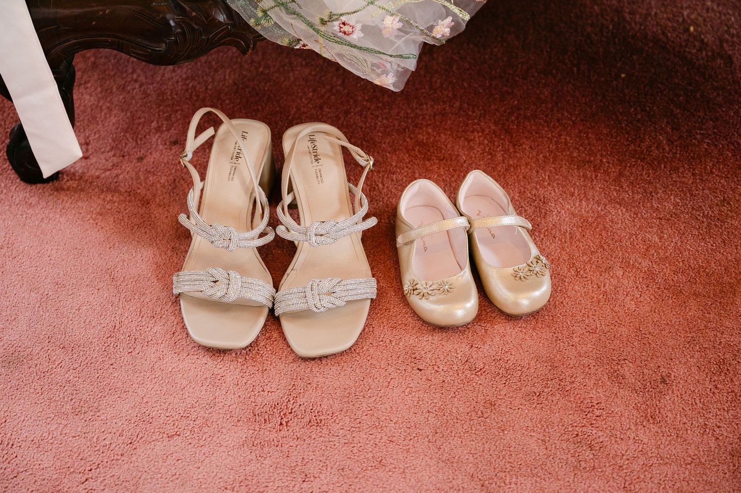 The Historic Concord Exchange Minneapolis MN. Elegant bridal sandals and flower girl shoes displayed on red carpet for a wedding ceremony.