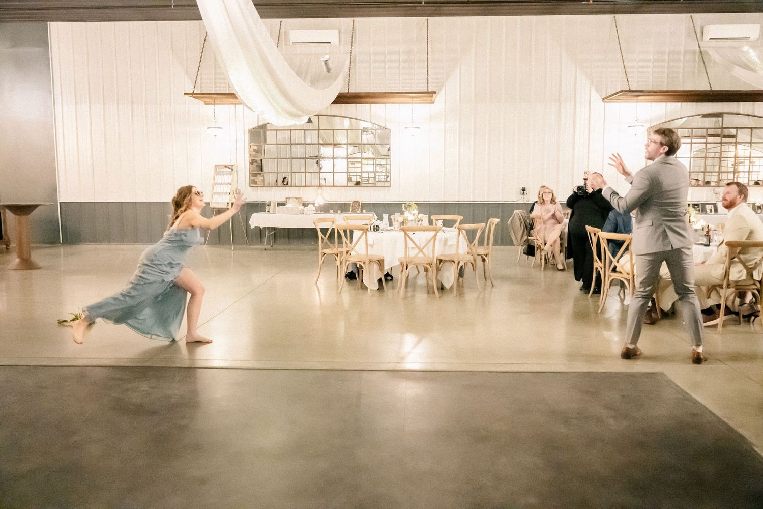 Wedding guests perform a fun dance routine on the reception hall floor during the celebration.