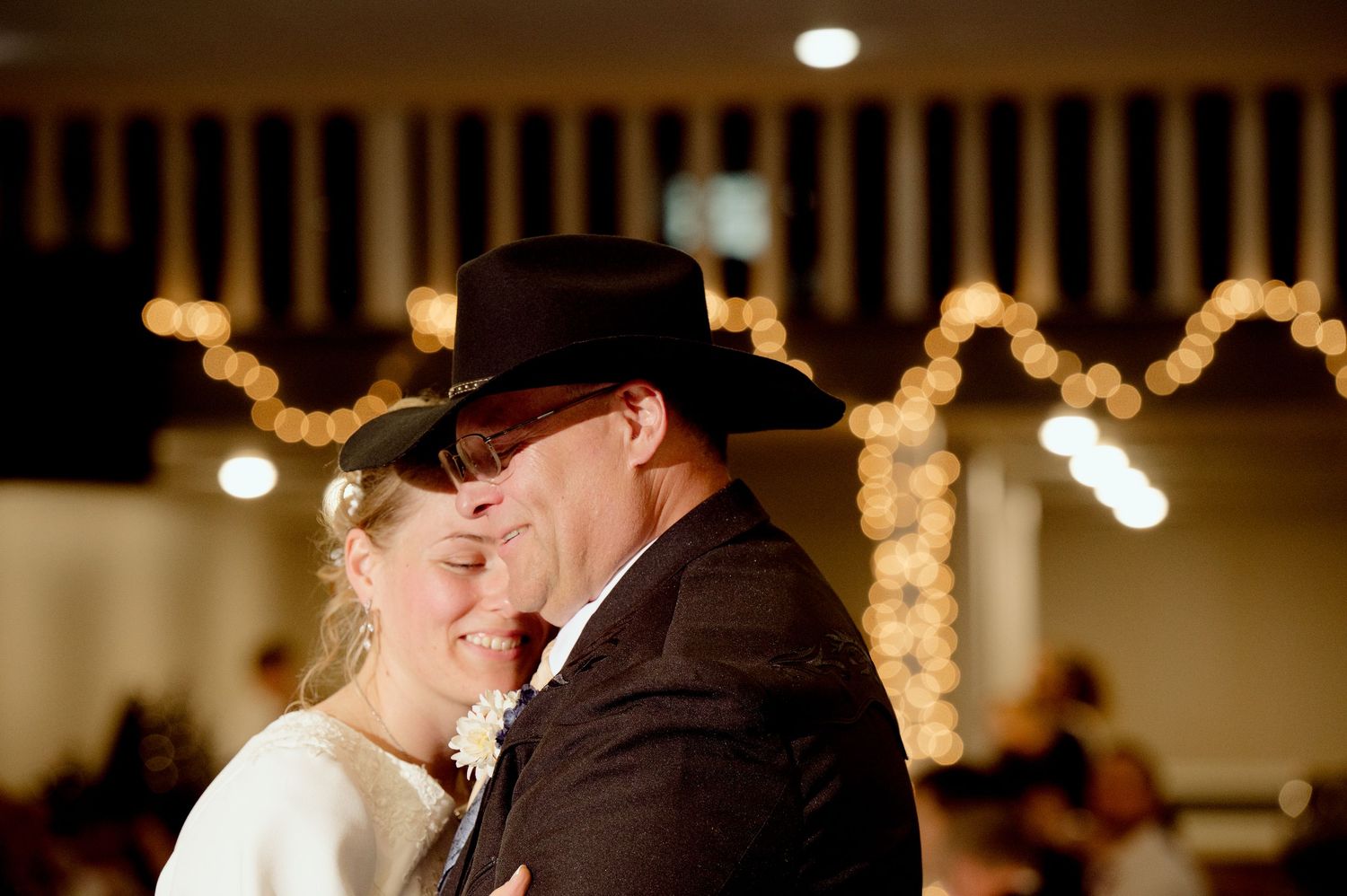 Romantic evening wedding reception scene with twinkle lights creating an intimate atmosphere.