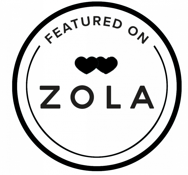 Black and white circular badge reading Featured on Zola with two heart icons, wedding registry platform logo.