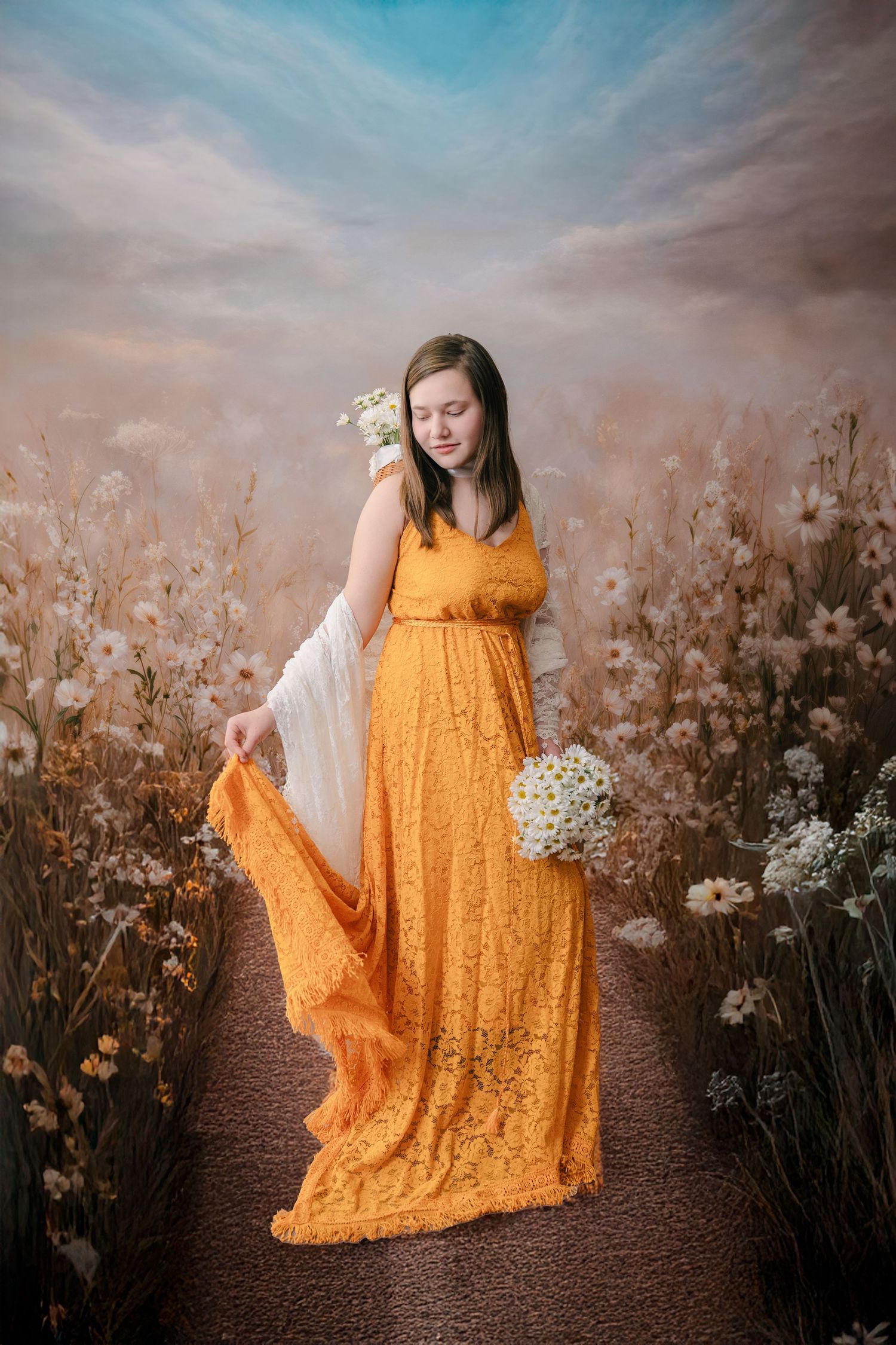 A flowing yellow lace dress catches movement against a dreamy backdrop of wildflowers at sunset.