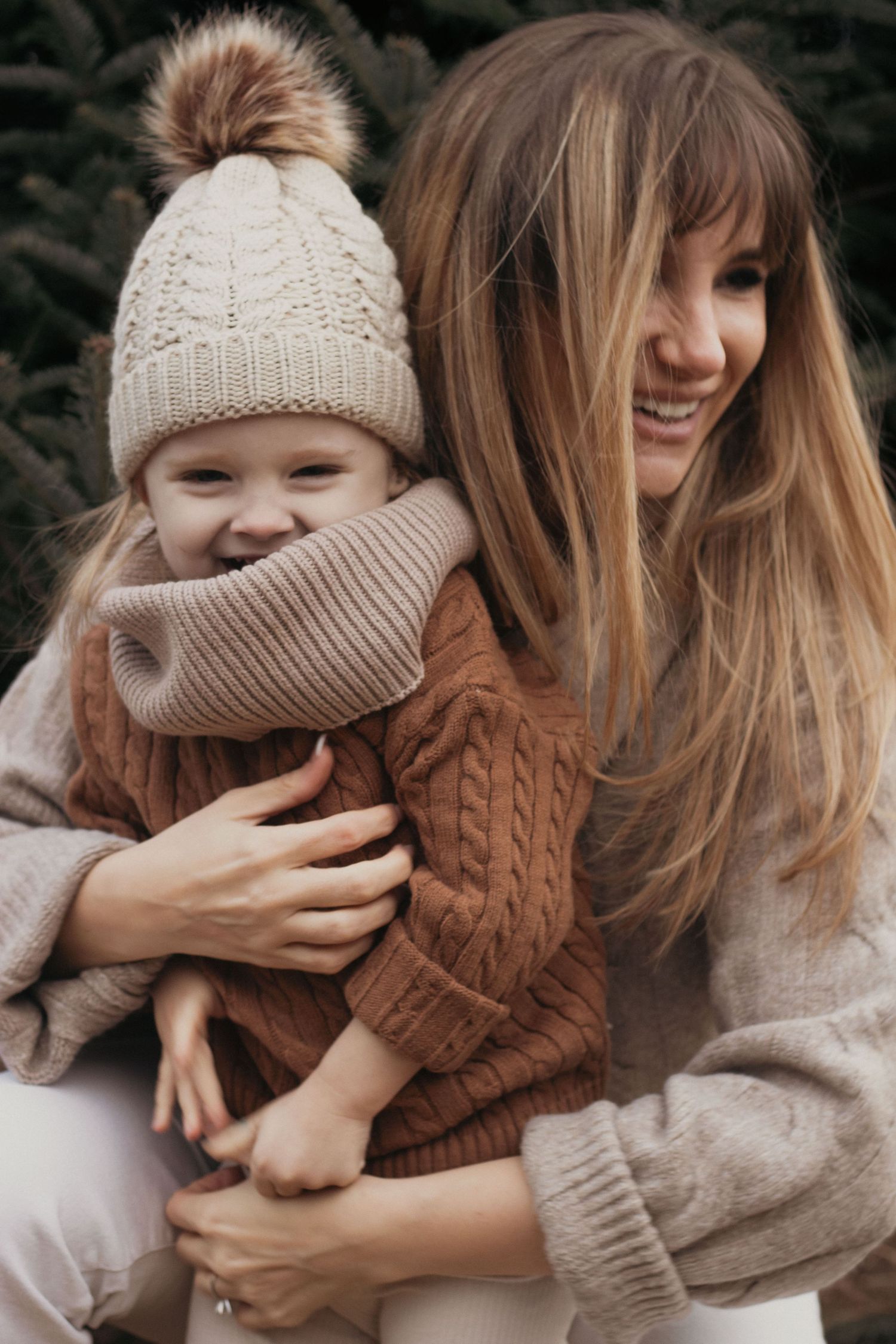 Candid winter moments with knit accessories and cozy brown sweaters against a dark background.