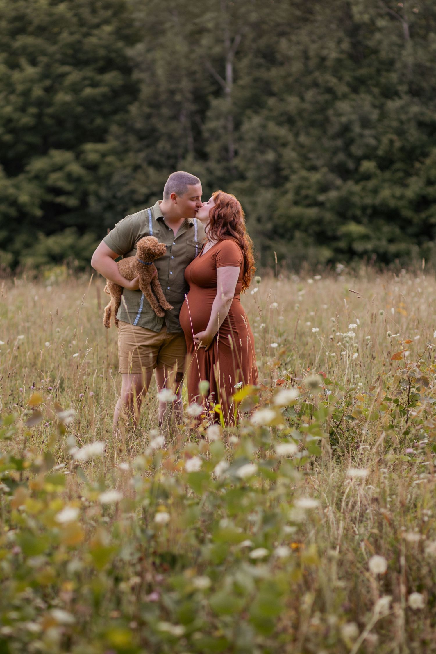 Playful candid moments captured in a rustic field filled with wildflowers.