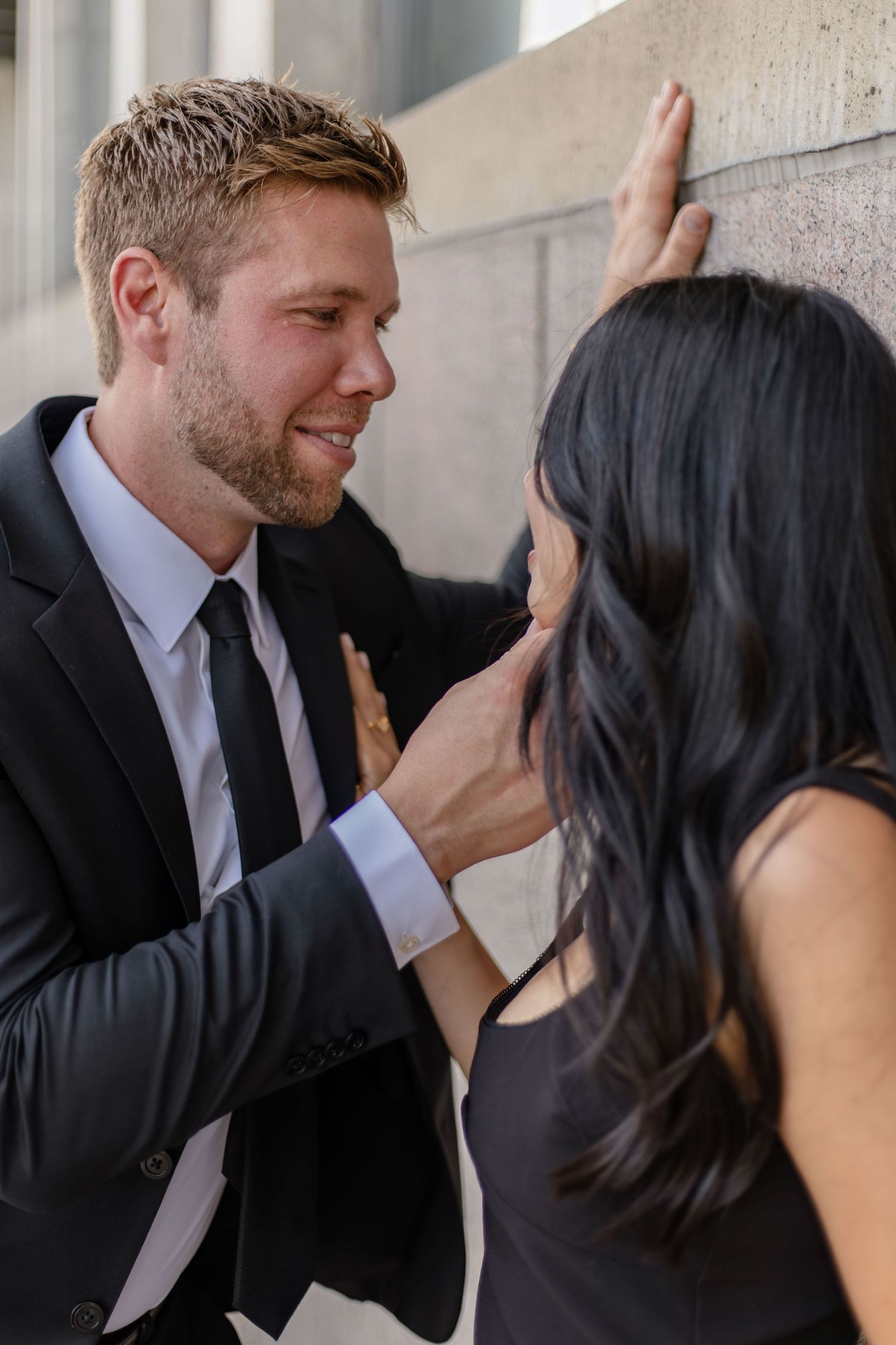 Romantic sequence showing a couple in black and white attire sharing tender moments.