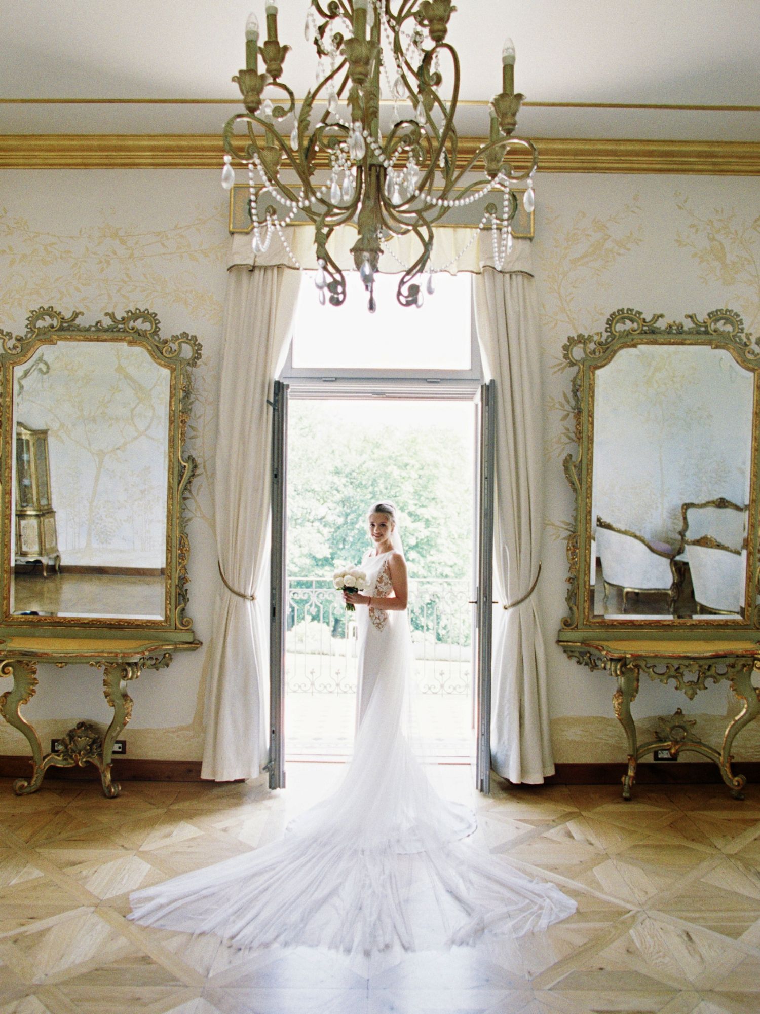 Top wedding photographer captures a bride in a luxurious room at Chateau Mcely.