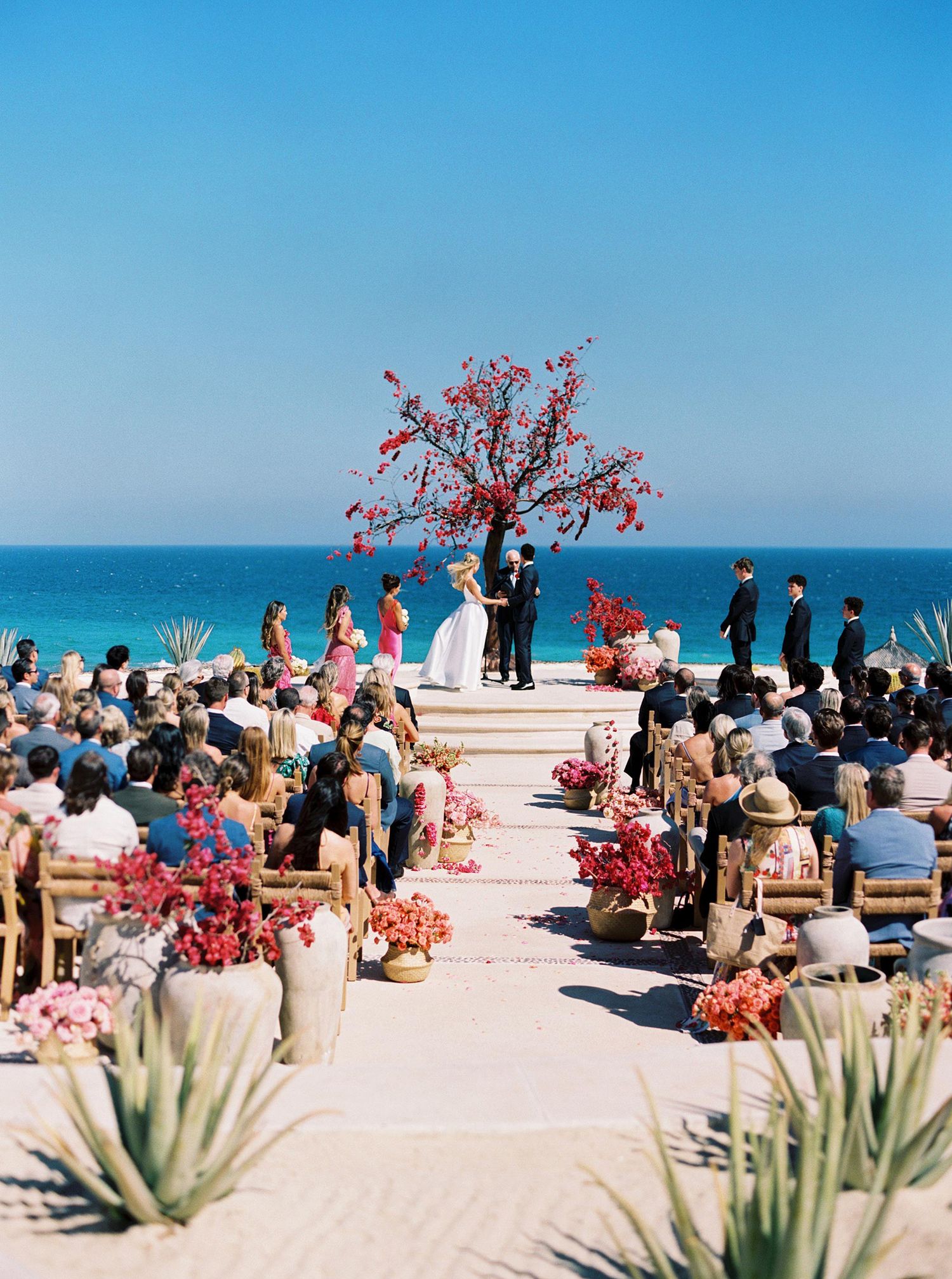 Oceanfront wedding ceremony at Las Ventanas al Paraíso, Los Cabos, Mexico, with vibrant florals and stunning sea views.