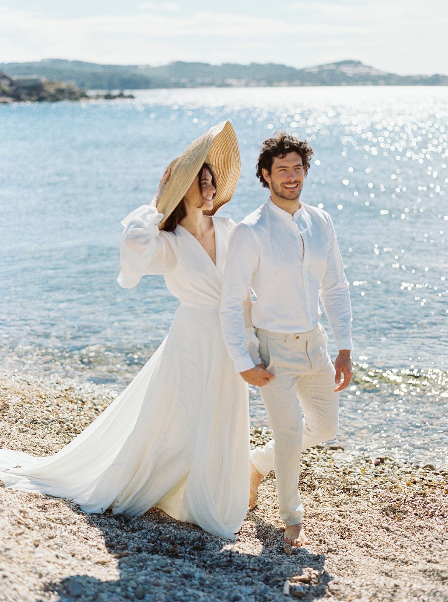 Romantic wedding portrait at Château de Mar Vivo, French Riviera, featuring a couple strolling on the beach.