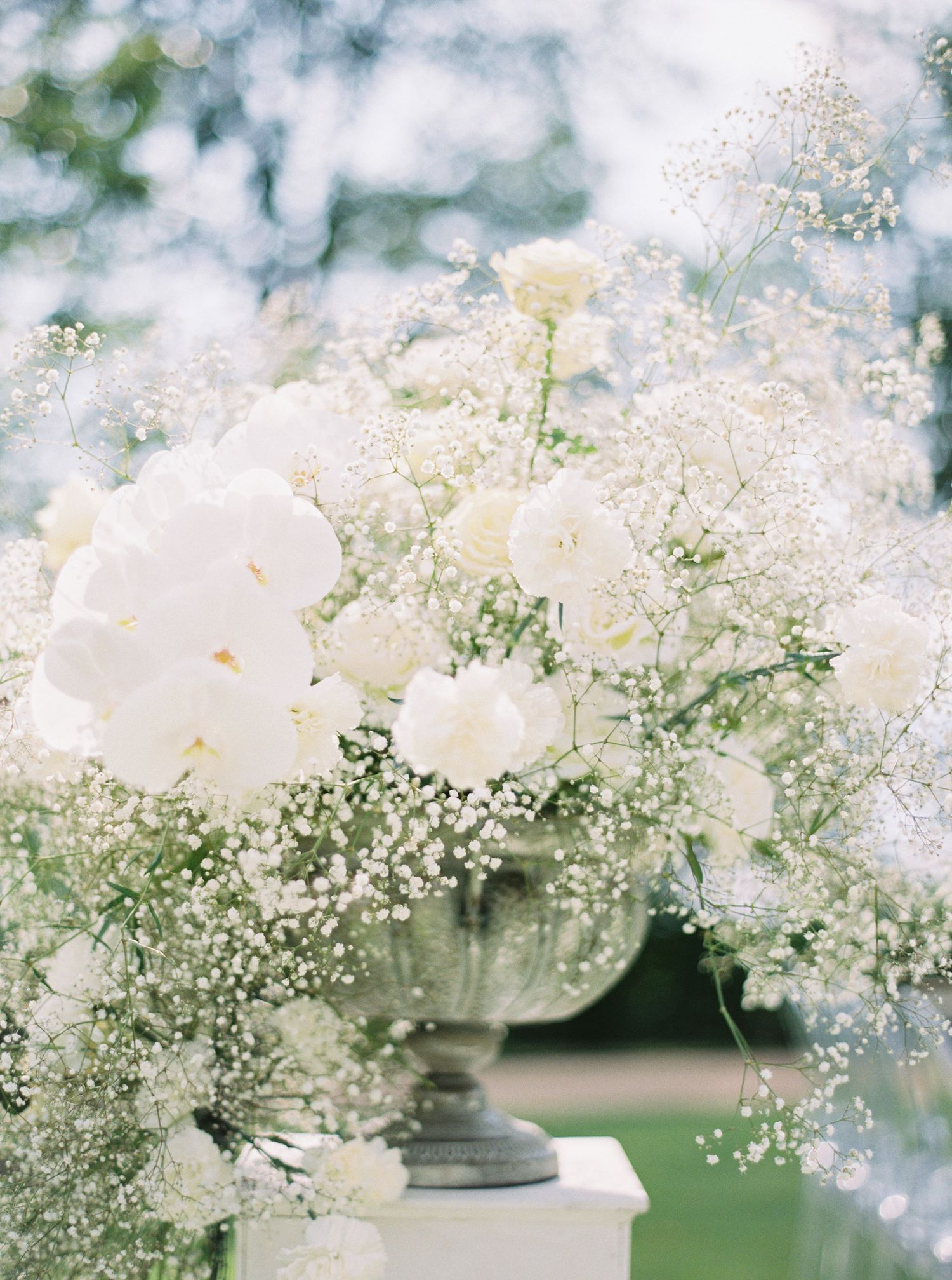 Elegant white wedding flowers in a vase, beautifully captured at Chateau Mcely by a top wedding photographer.