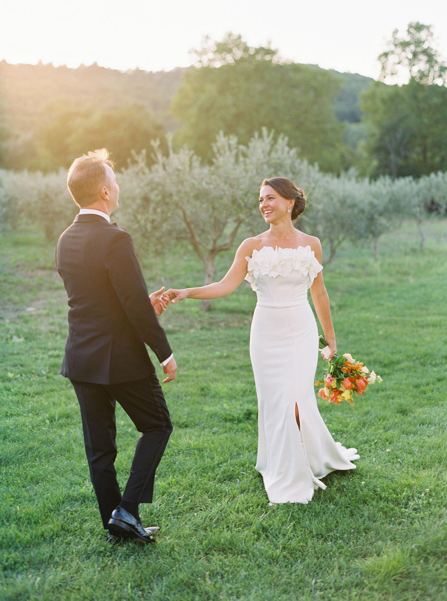 Romantic wedding portrait at Château La Coste, Provence, France, with joyful couple in olive grove at golden hour.