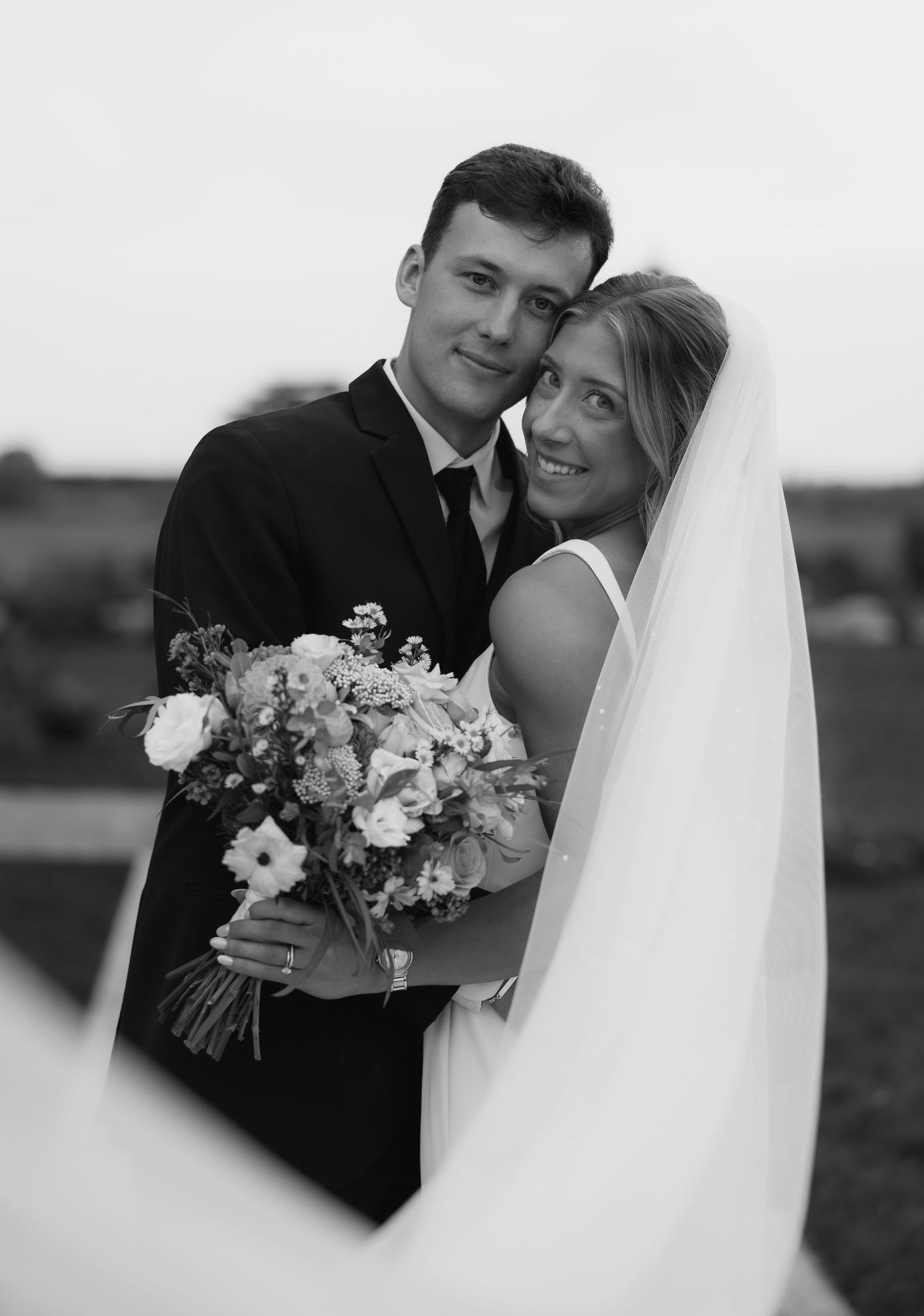 A romantic black and white wedding photography collage showing tender moments between newlyweds with floral bouquet details.