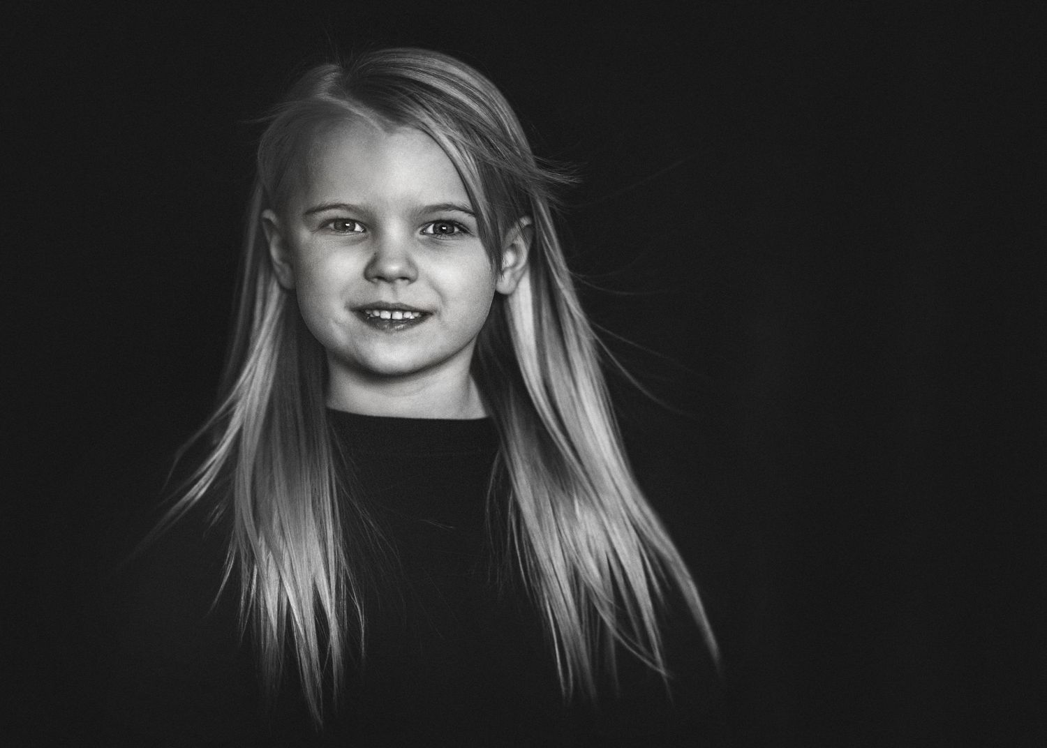 Black and white studio image of little girl