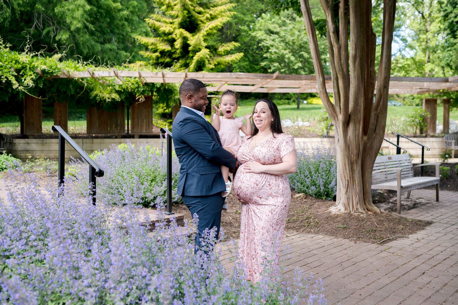 People sharing a joyful moment together in a blooming lavender garden on a sunny day.