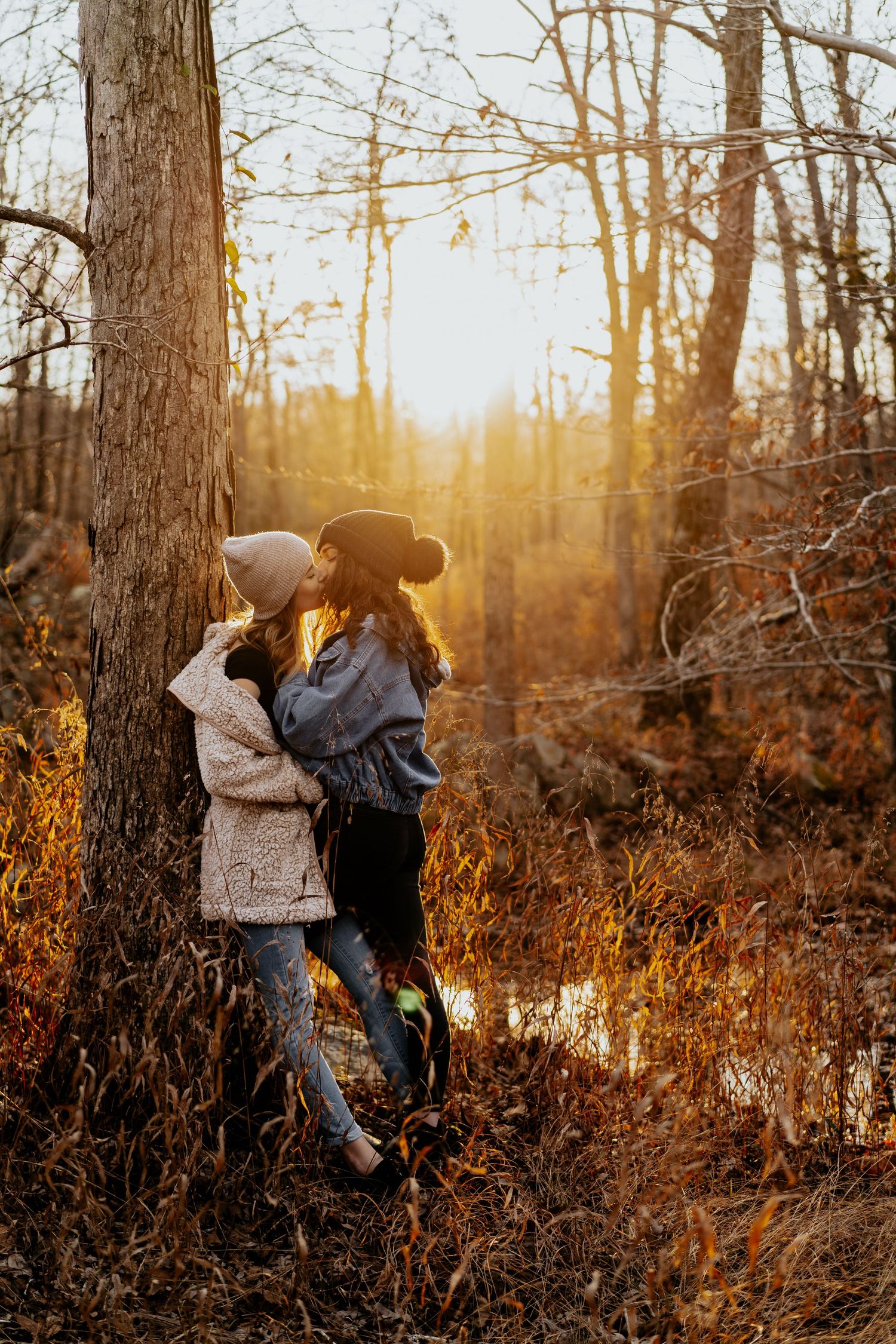 Lesbian couple kissing at sunset at Great Falls Park, MD
