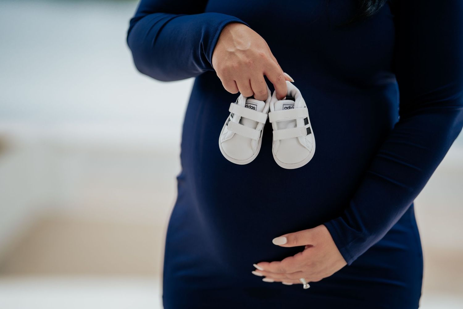 Pregnant woman in flowing dress during golden hour maternity session in Washington, DC