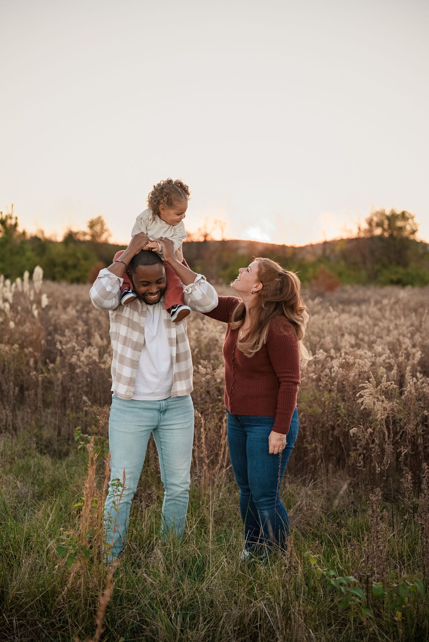 family of three in a frederick, md field at sunset
