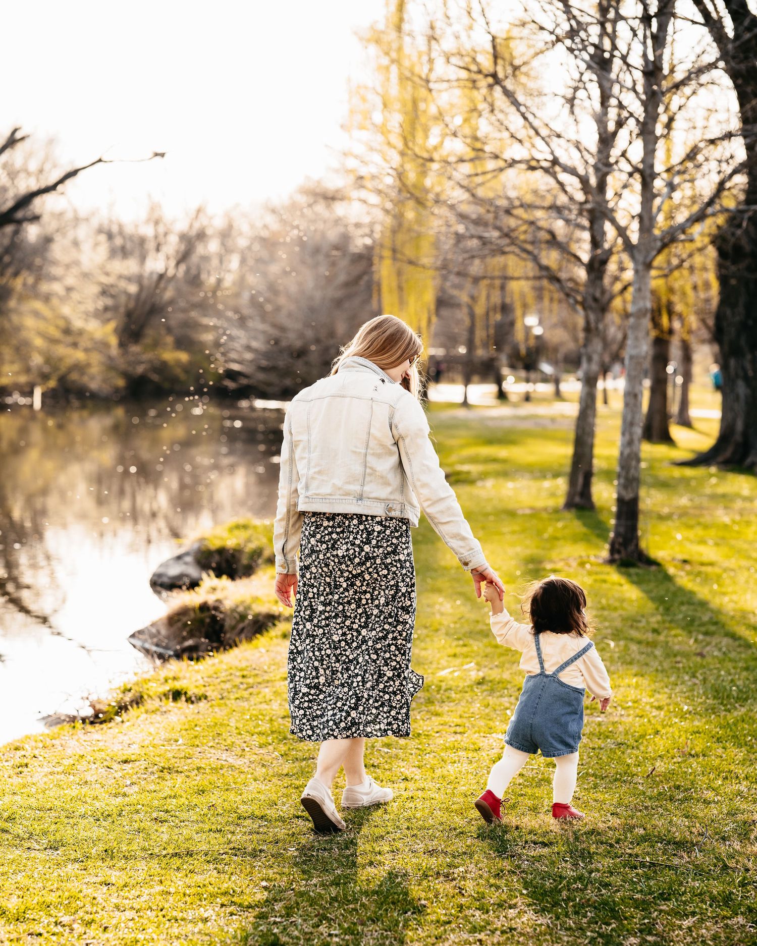 mommy and daughter walking together at Baker Park in Frederick Maryland