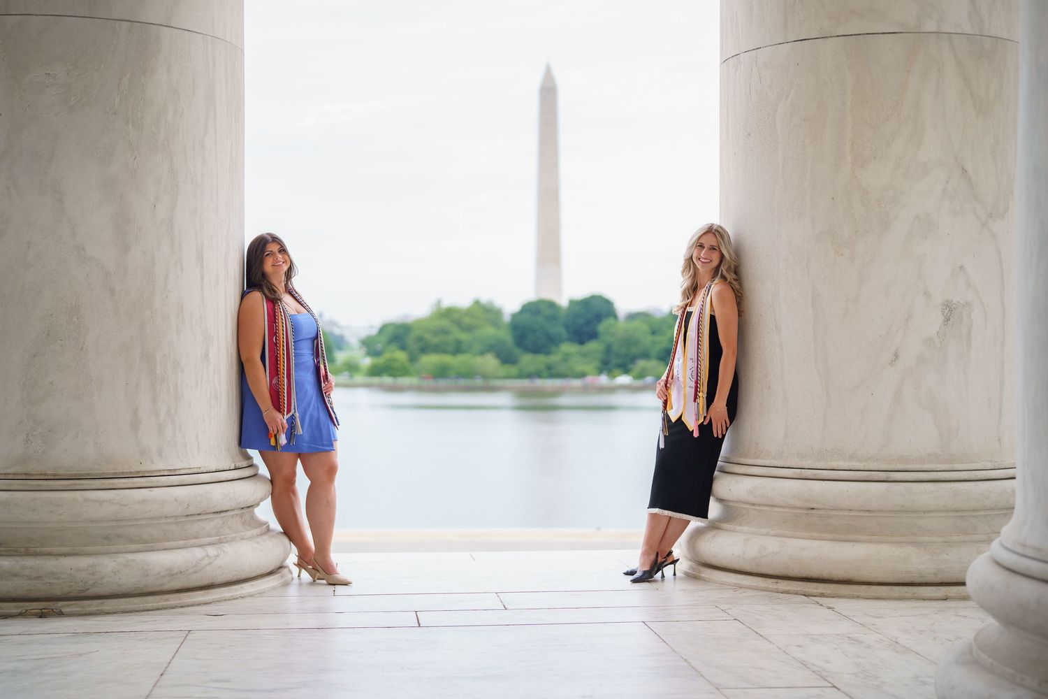 graduation session with graduate posing at the Jefferson Memorial with the Washington Monument in background, in Washington DC