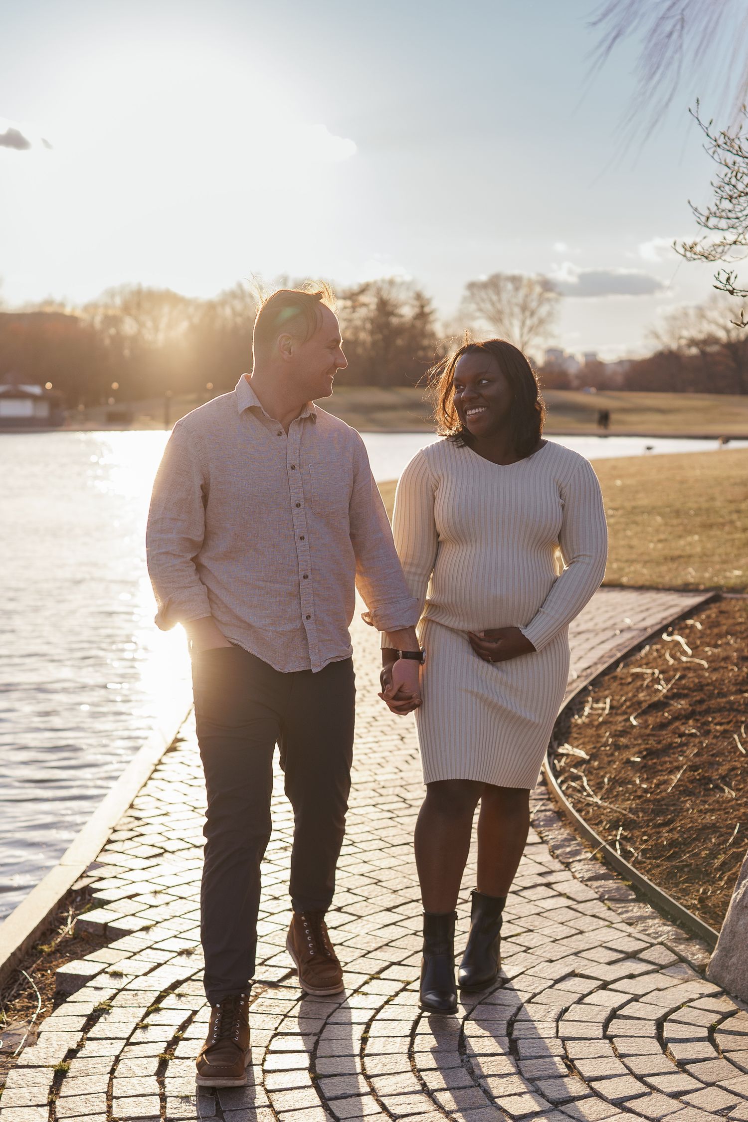 Expecting couple sharing a quiet moment in at constitution garden in washington DC.