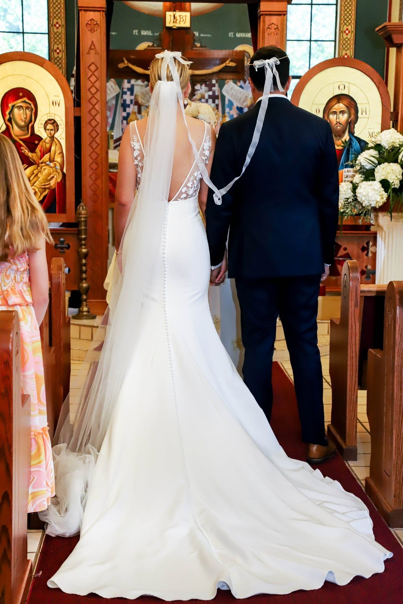 Bride and groom stand at the altar during a traditional Orthodox Greek wedding ceremony in Gainesville, Florida.
