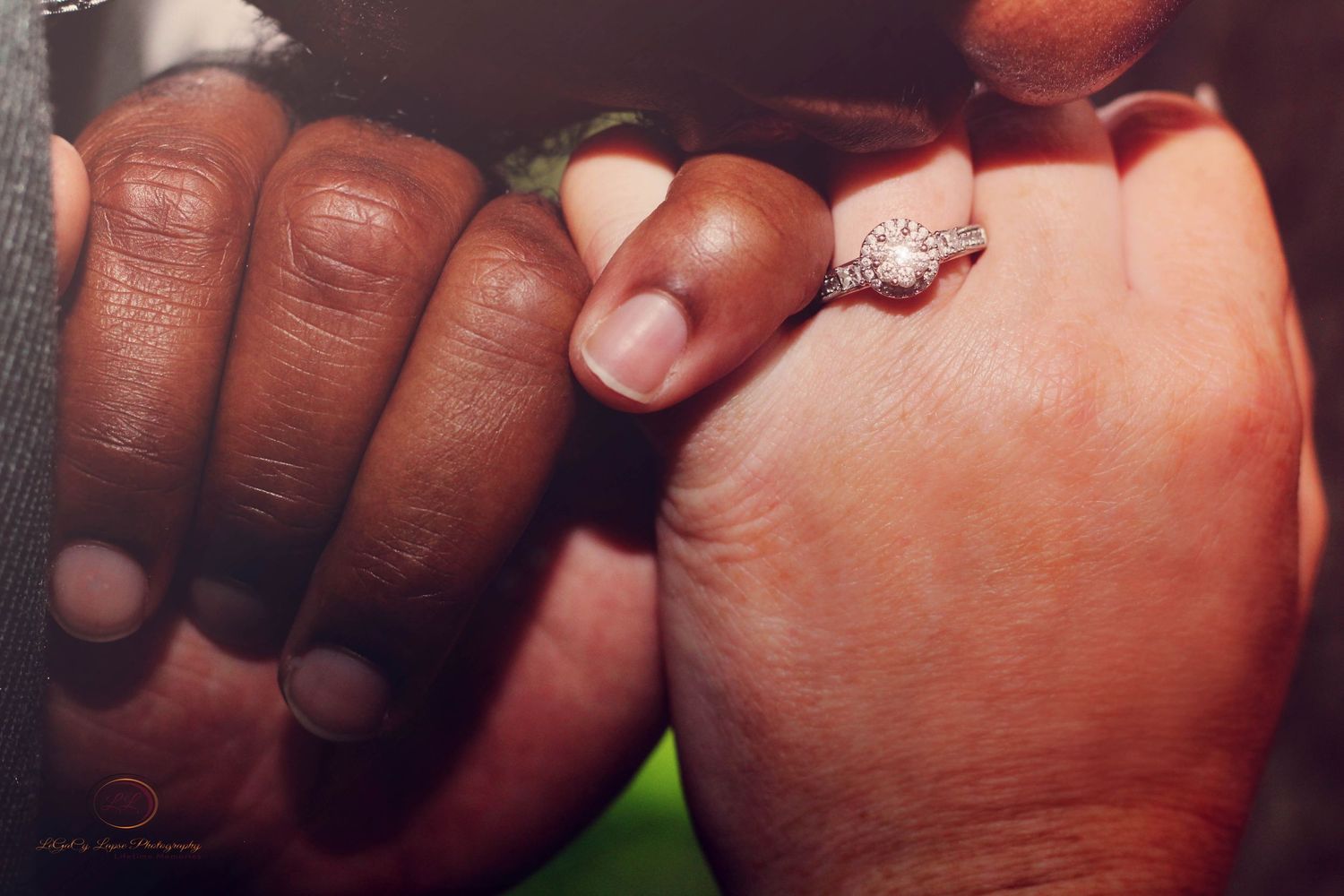 Photo Session of Close-up of two hands holding together with a sparkling diamond engagement ring in Gainesville Florida