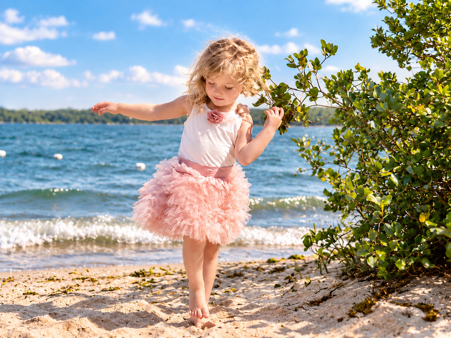Adorable little girl playing on the beach
