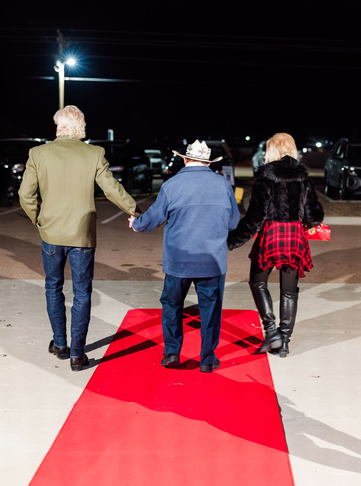 Guest arriving on red carpet at Night to Shine event, escorted by volunteers, capturing a joyful, inclusive evening celebration and VIP expe