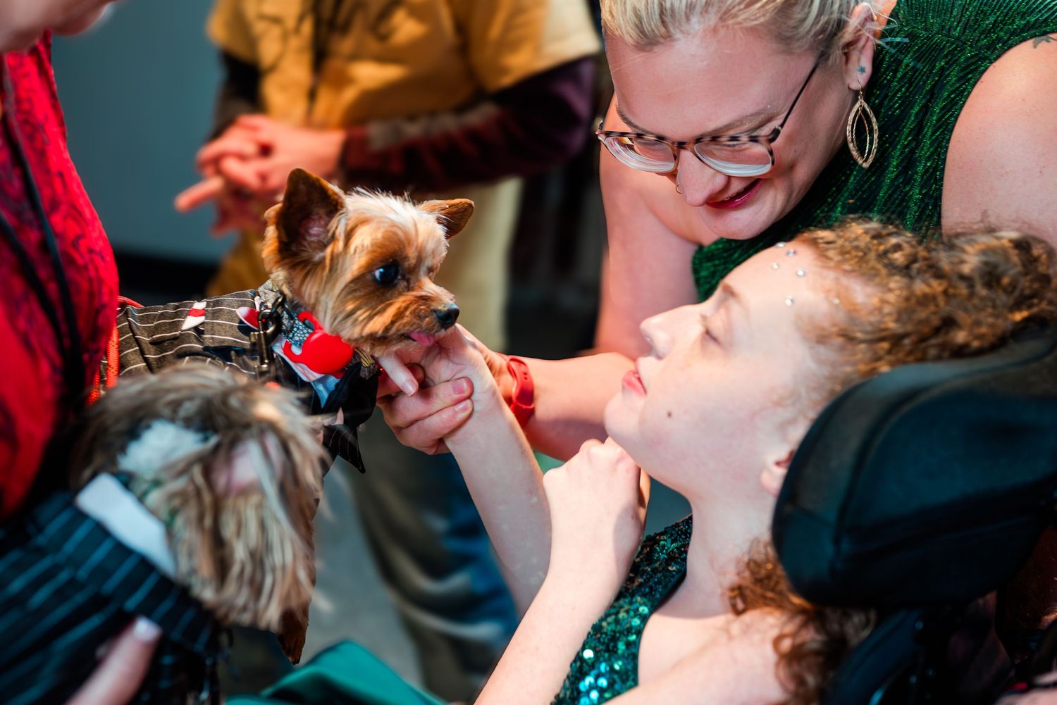 Guest meets a dressed-up therapy dog at Night to Shine, sharing a joyful, gentle moment that highlights connection, comfort, and inclusive c