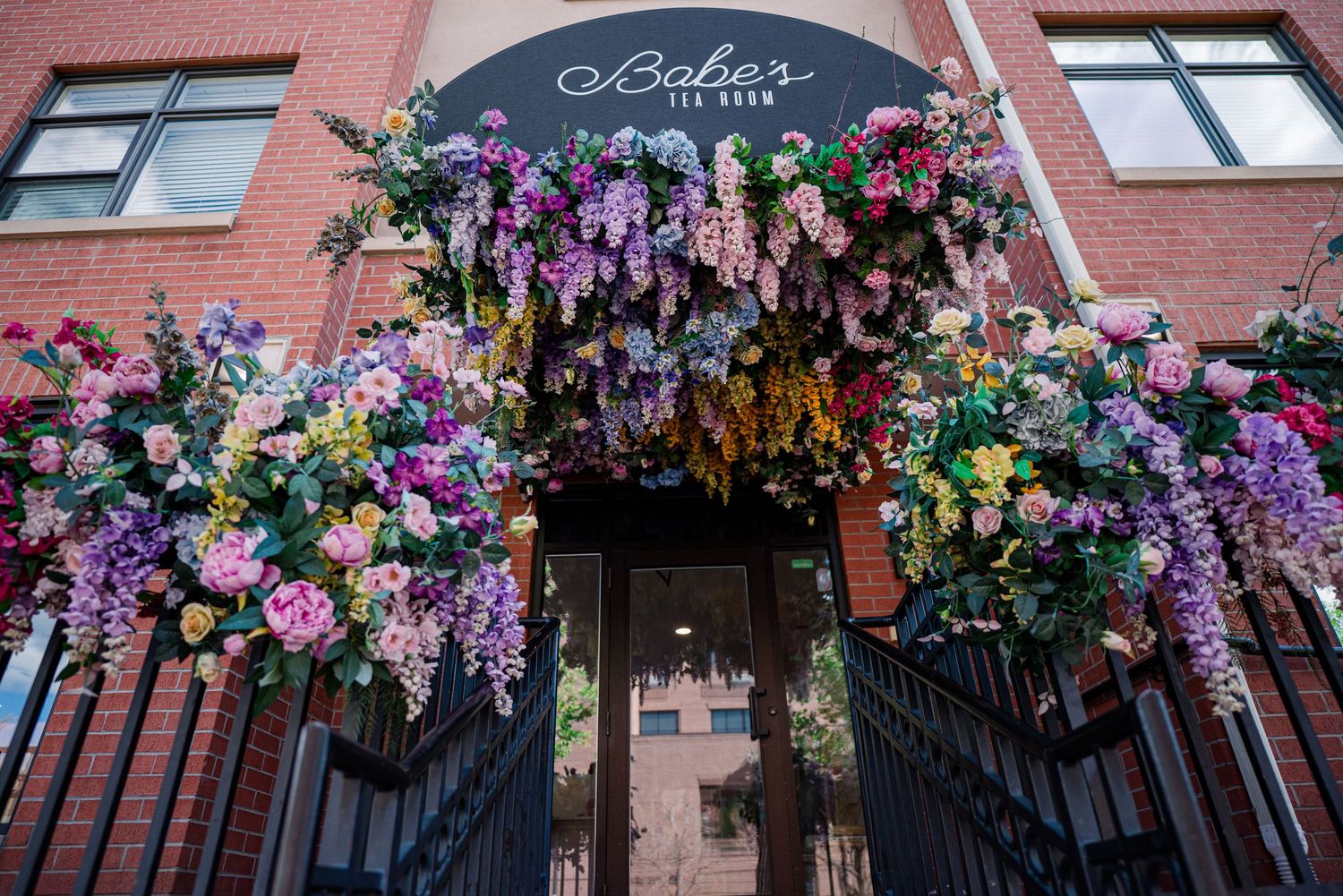 Floral entrance at Babe’s Tea Room in Golden Colorado, wedding venue detail photography, colorful event decor Denver photographer