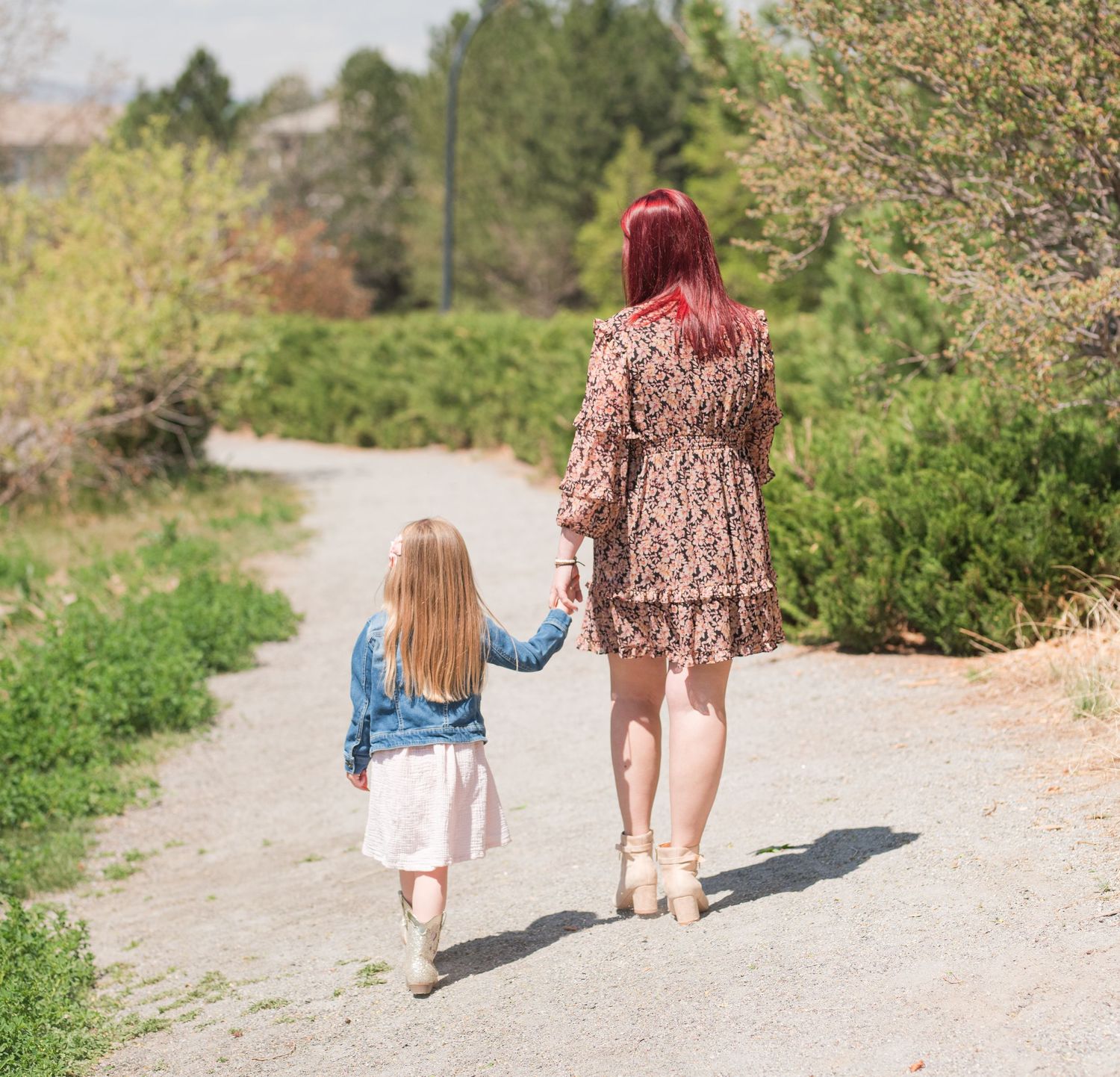 Mom and daughter walking hand in hand on path, candid Colorado family photography, natural light Denver photographer spring time mothers day