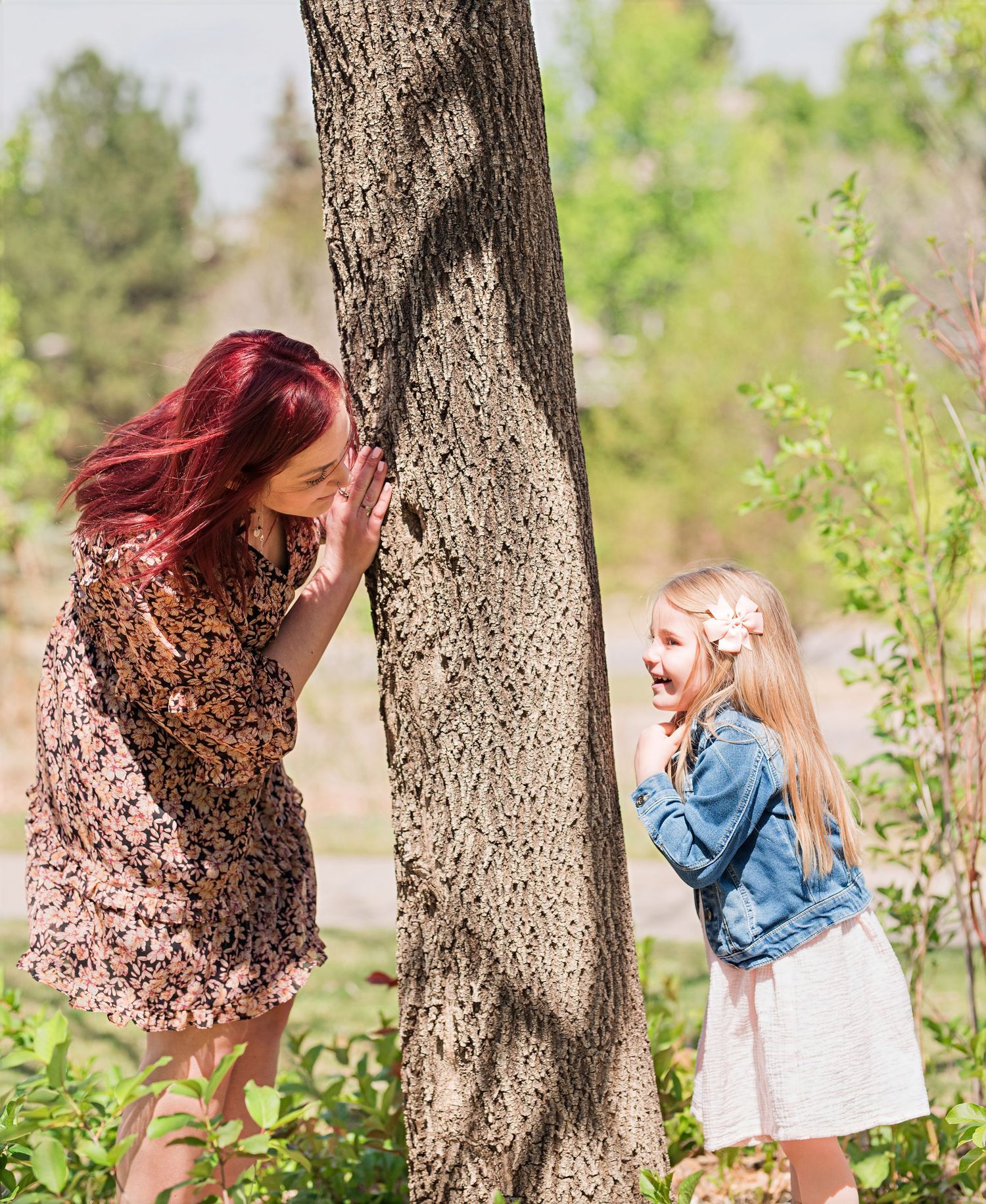 Playful mommy and me photo of mother and daughter by tree, candid Colorado family photography, natural light Denver photographer single mom