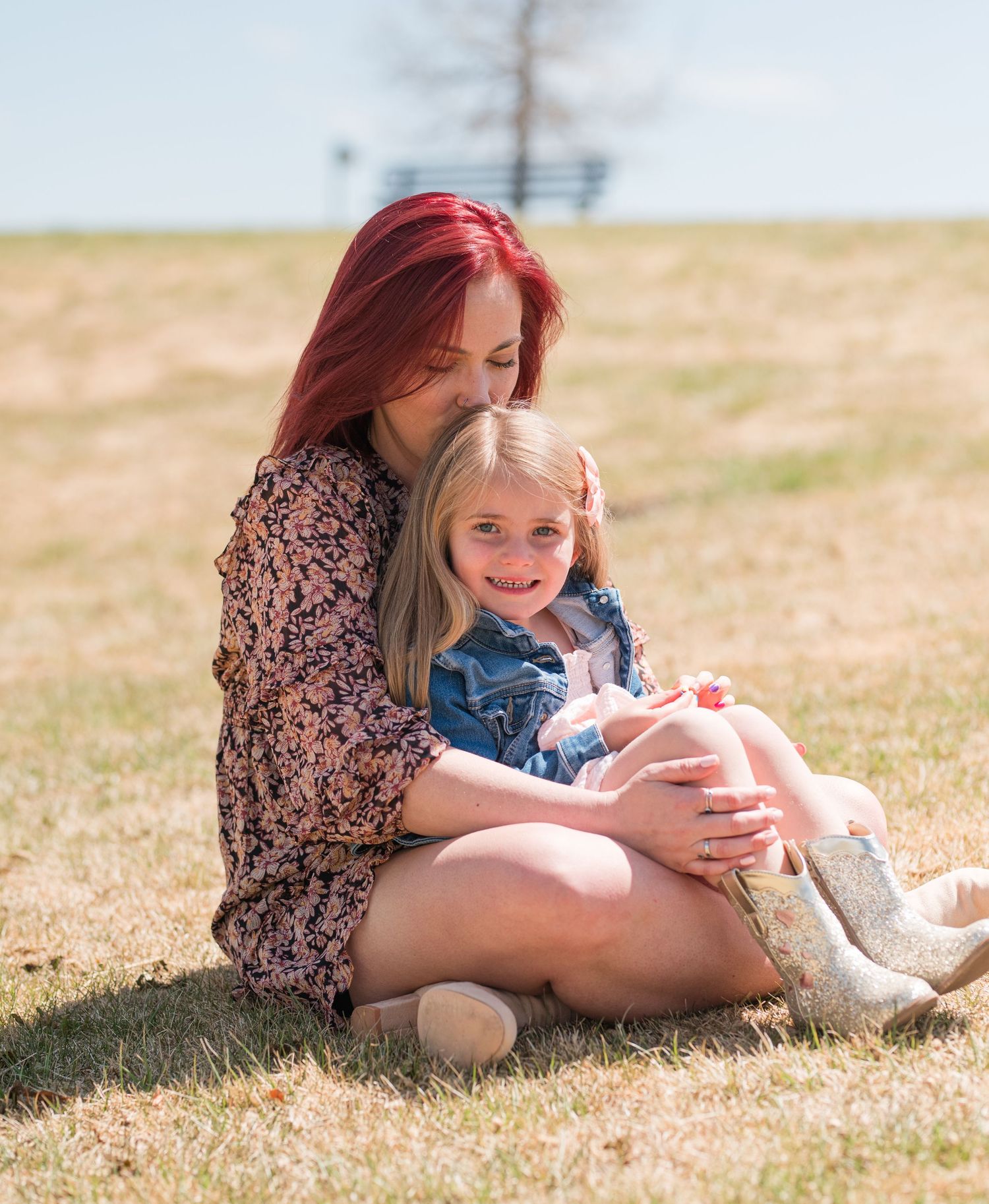 Mommy and me photo of mother kissing daughter on head, candid Colorado family photography in natural light, Denver family photographer quiet