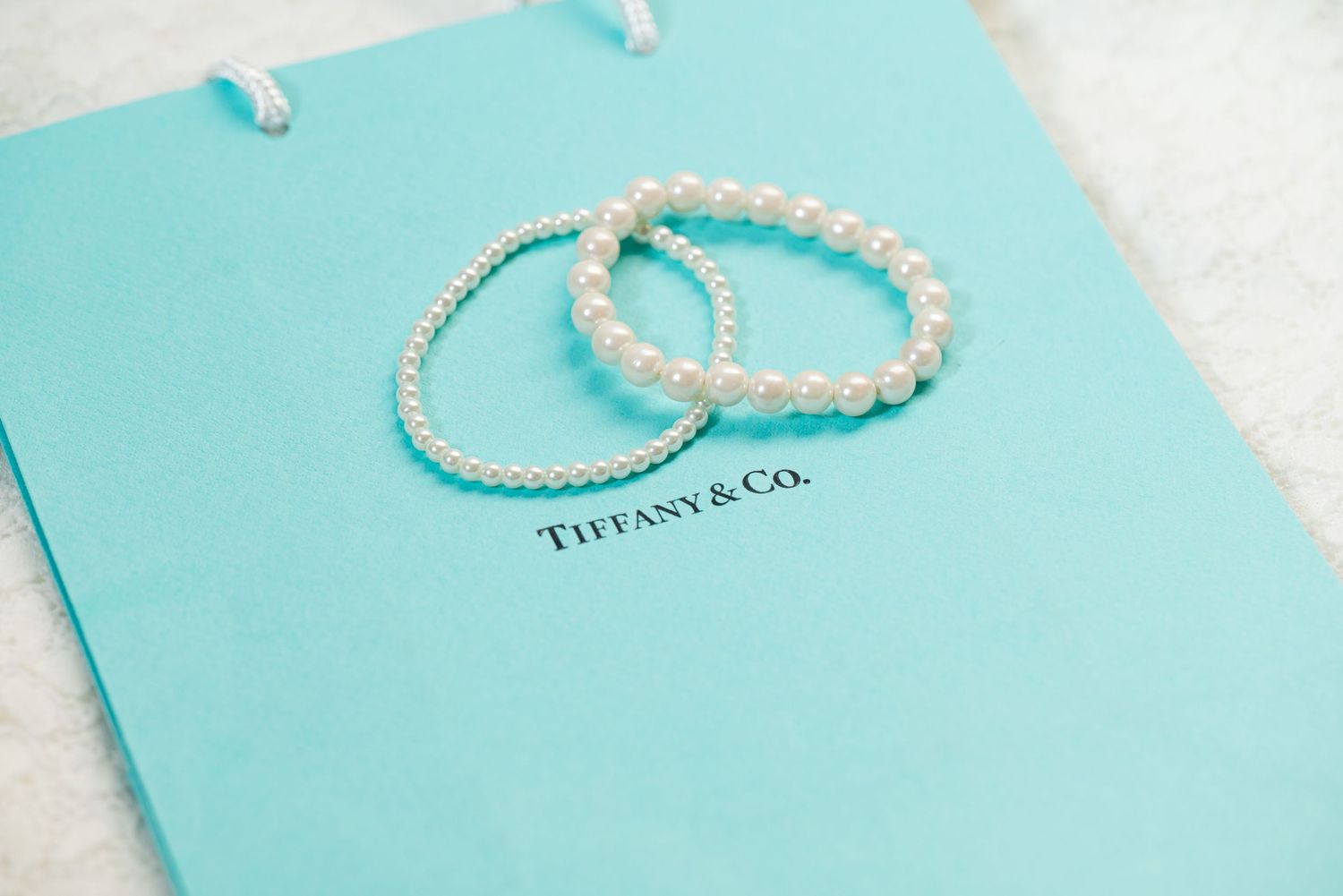 Pearl bracelets on Tiffany and Co box, elegant wedding detail photography, bridal accessories Colorado photographer