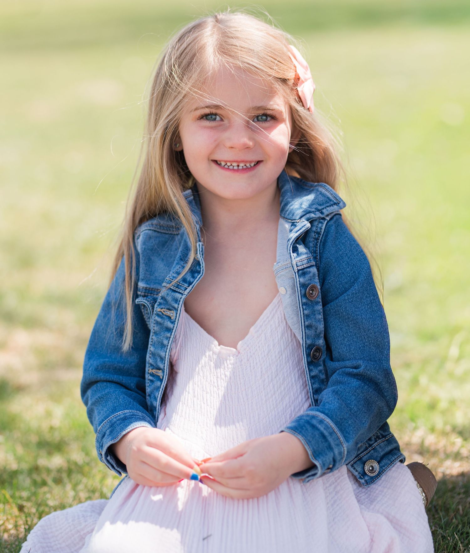 Portrait of smiling 4 year old girl outdoors, natural light Colorado family photography, Denver child photographer blond hair pink bow pink