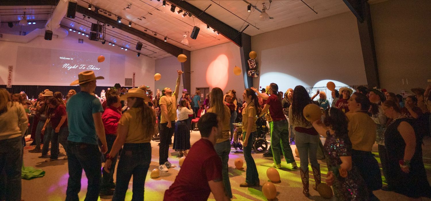 Crowd dancing at Night to Shine event, candid Colorado event photography, lively celebration Denver photographer