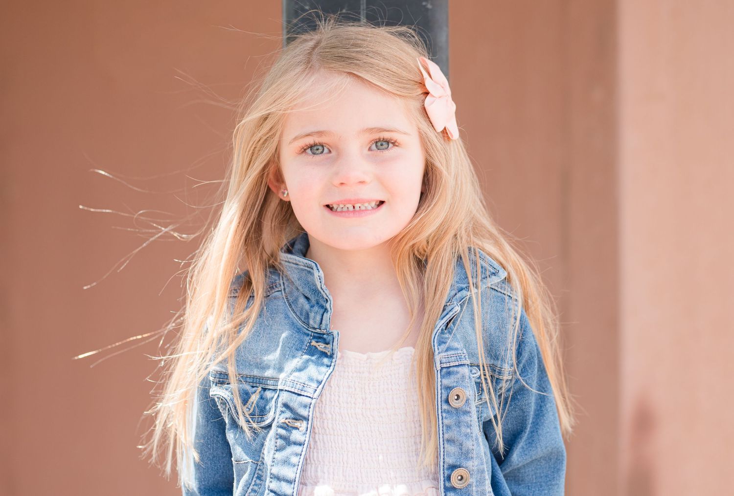 Portrait of smiling 4 year old girl in pink dress and denim jacket, natural light Colorado family photography, Denver child photographer