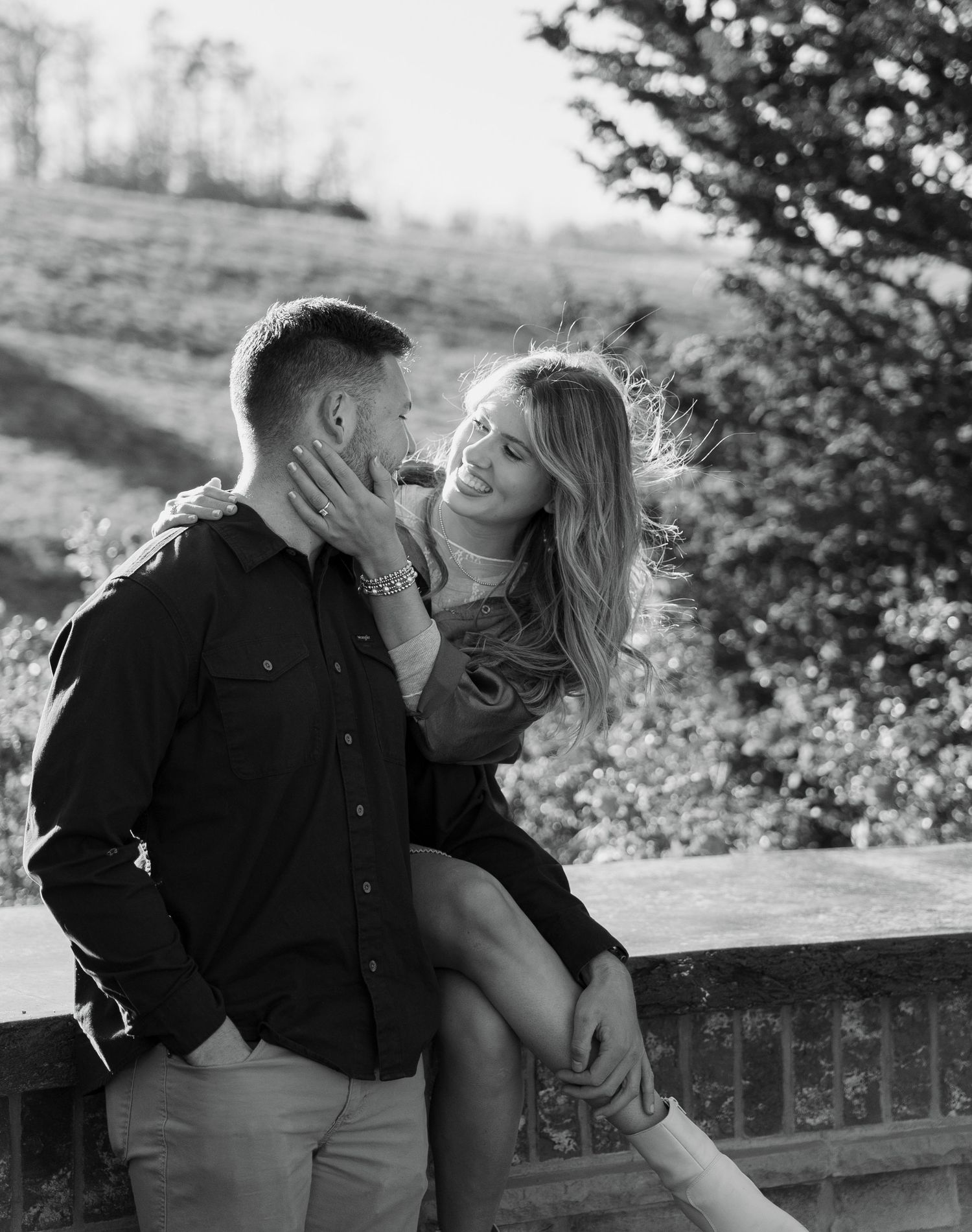 Black and white photo series capturing intimate moments between a couple outdoors.