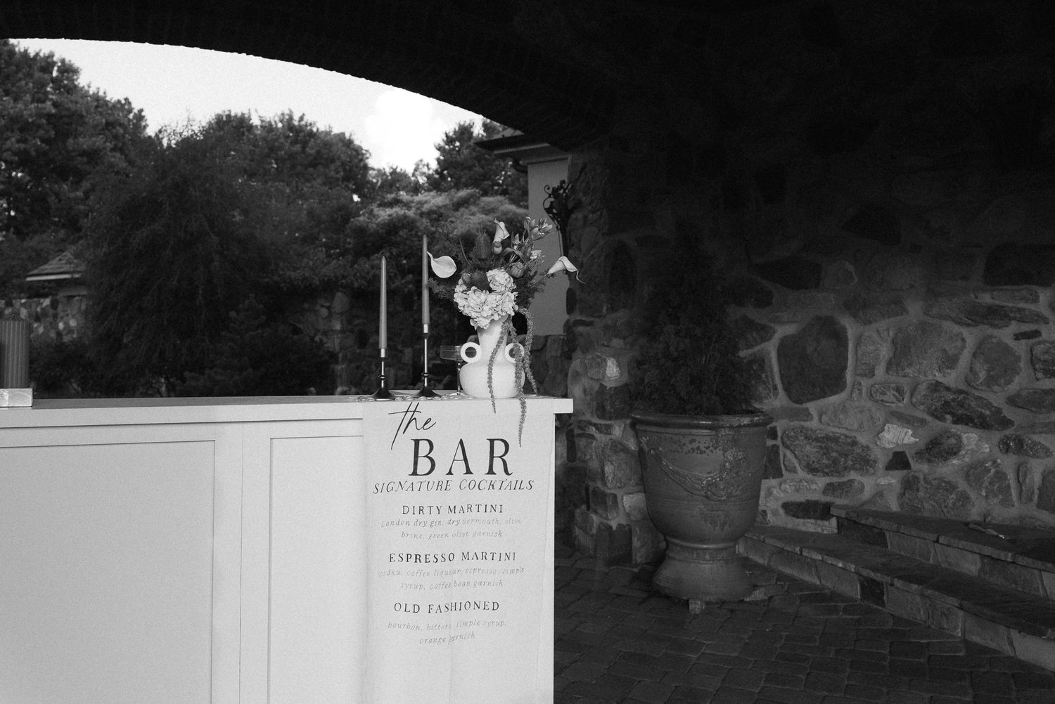 Black and white exterior shots of a bar entrance and signage at night.