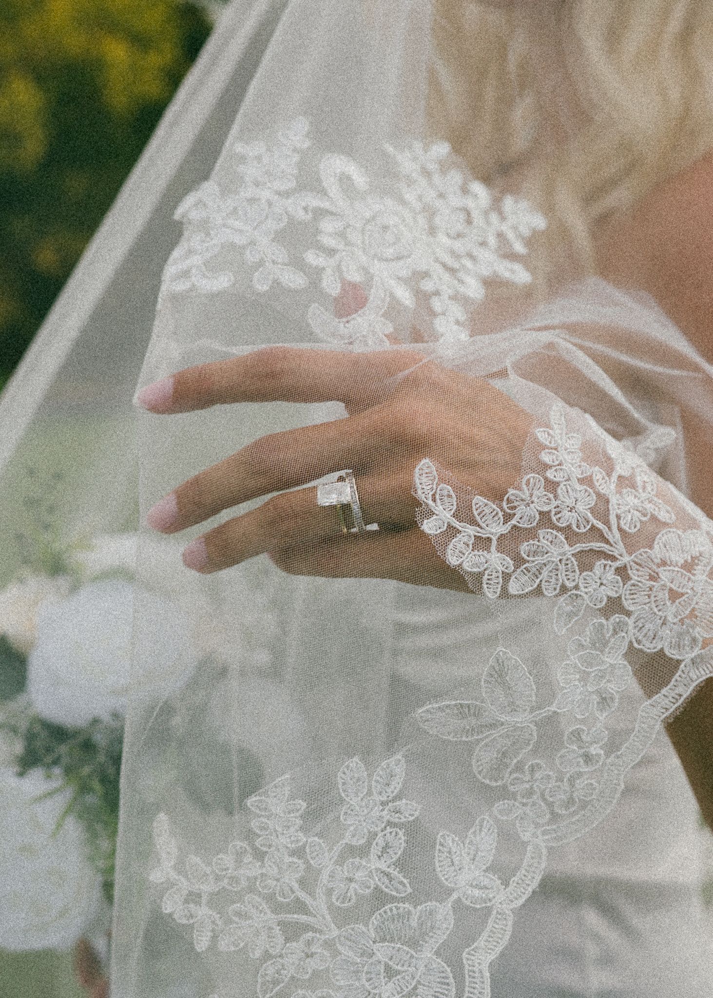Detailed view of floral lace appliques on a sheer wedding veil.