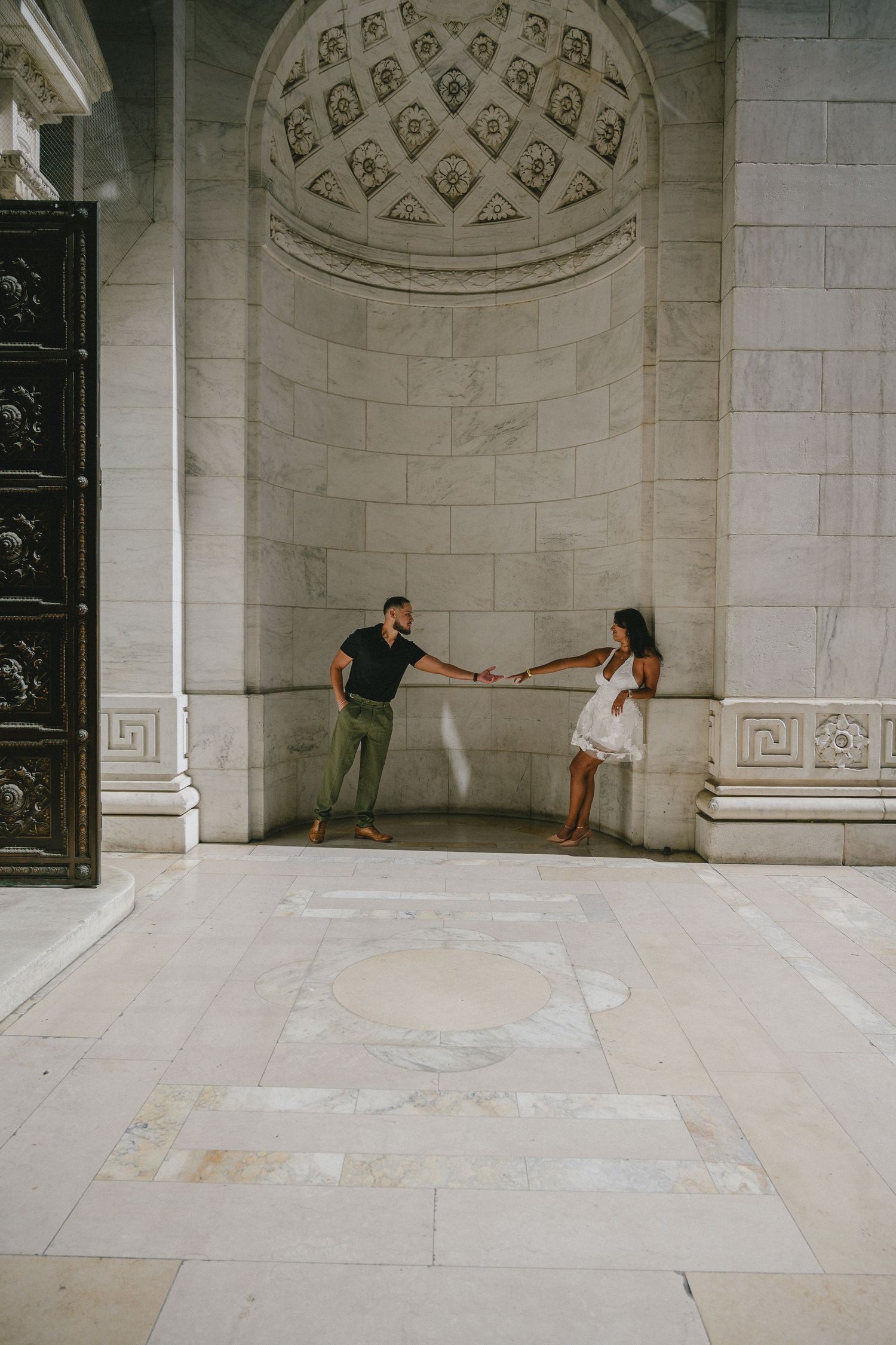 Architectural photography series showing people in a grand marble hallway with decorative ceiling details.
