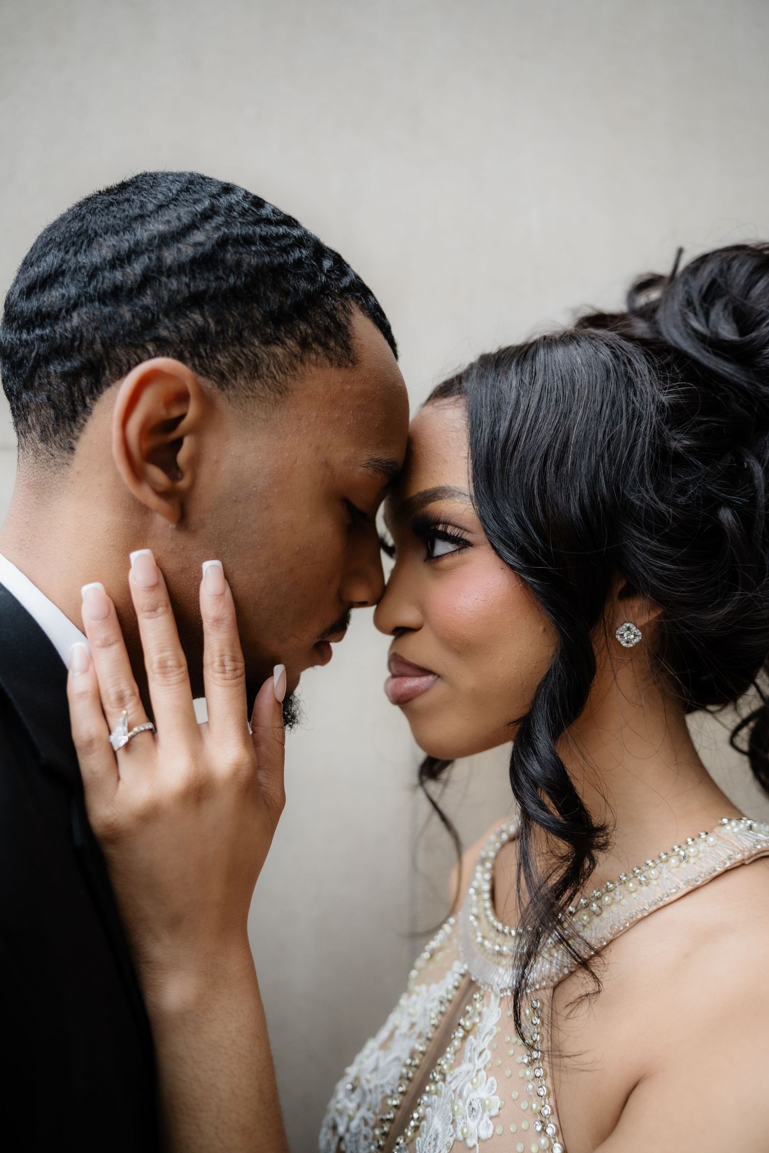 Romantic couple shares intimate moments in a series of wedding portraits against a neutral background.