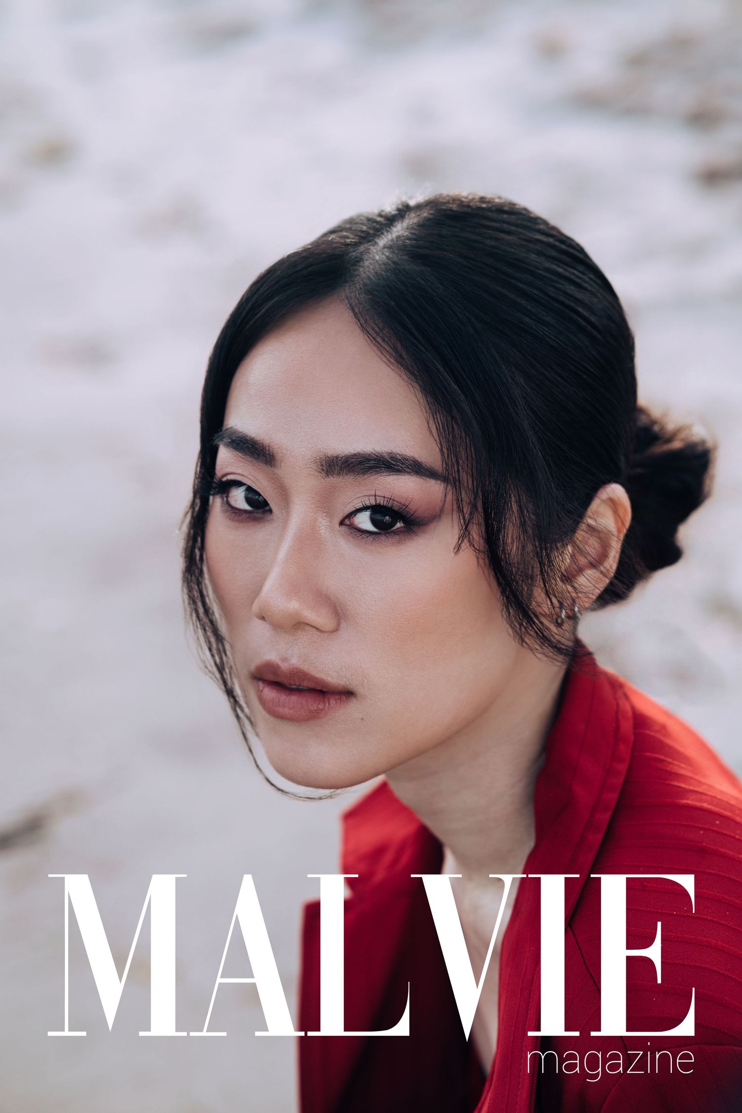 Woman in red top with elegant updo on MALVIE Magazine cover, showcasing natural beauty and sophistication.