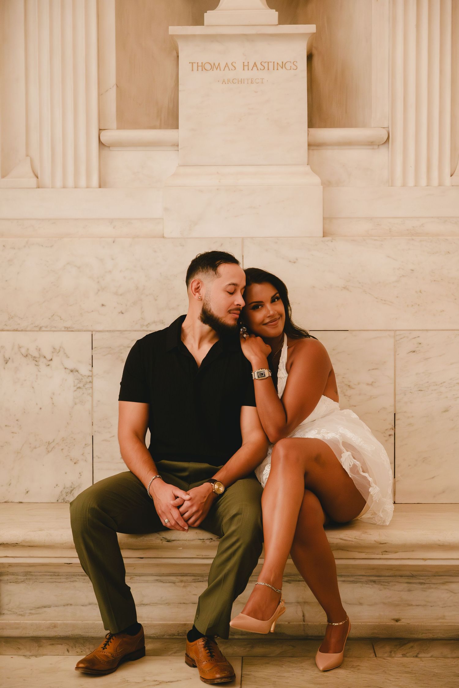 Romantic couple portrait session at a classical marble building with ornate architecture.