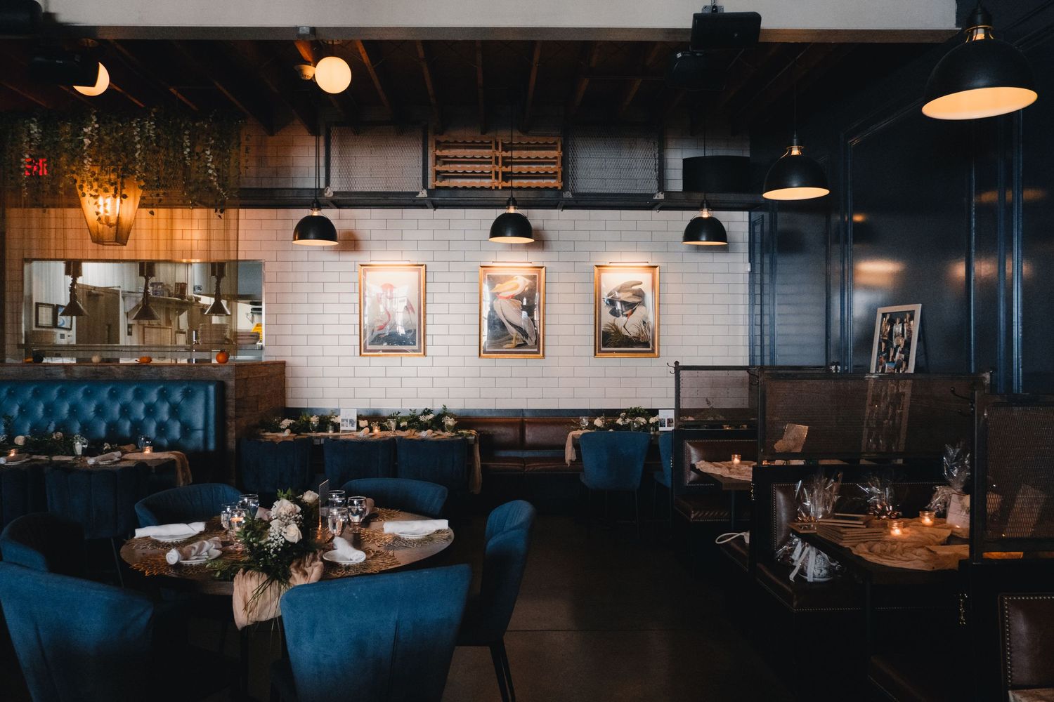 Dark and moody interior of a restaurant or event space with pendant lighting.